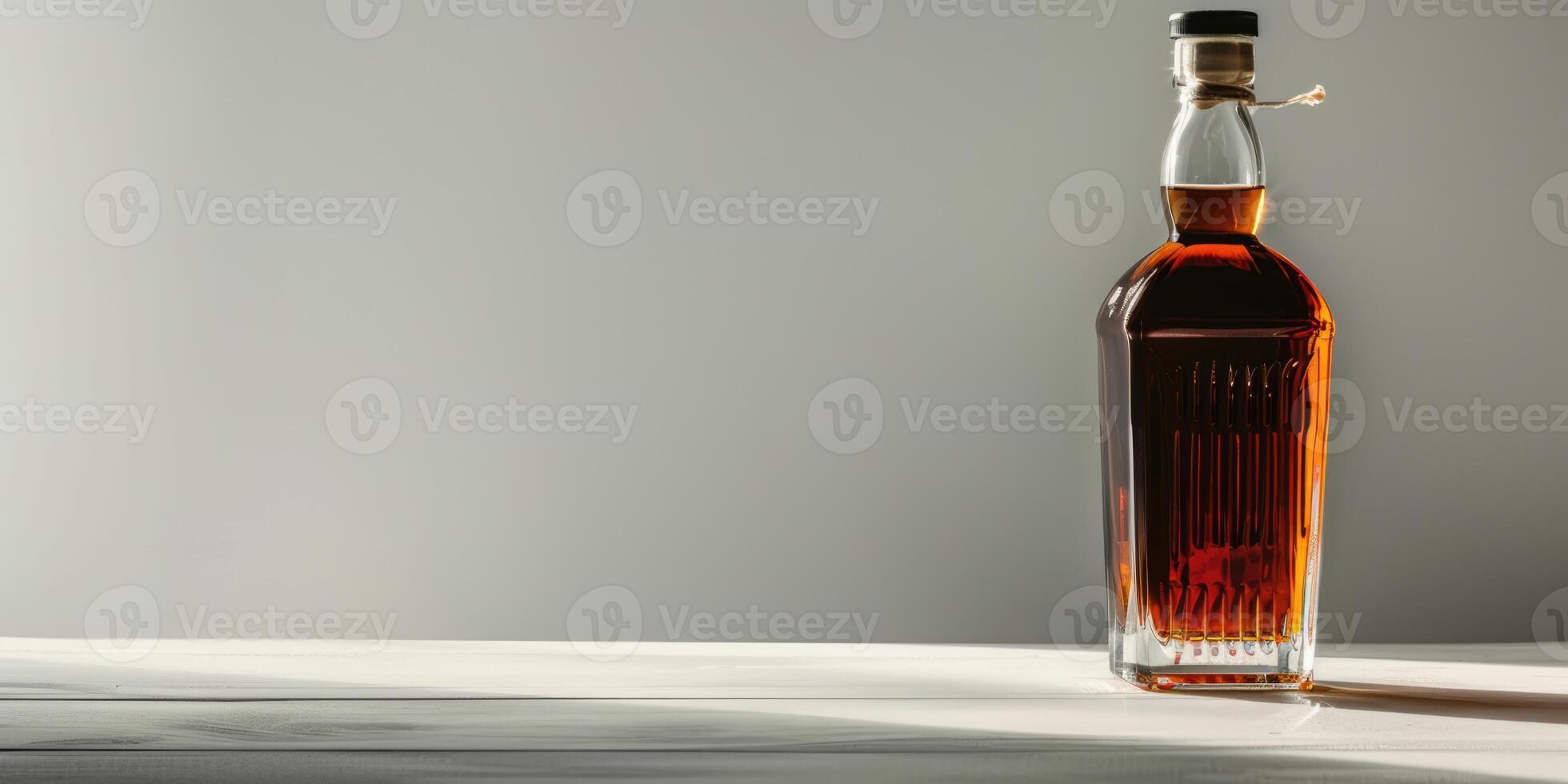 Whiskey or brandy bottle, alcohol drink isolated on grey background with copy space photo
