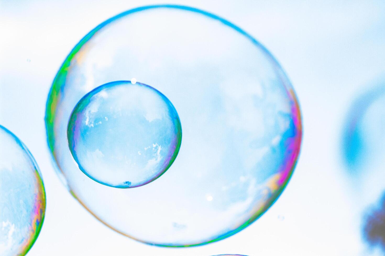 soap bubbles against the sky, reflection of the sun in the bubbles, color play, abstraction photo
