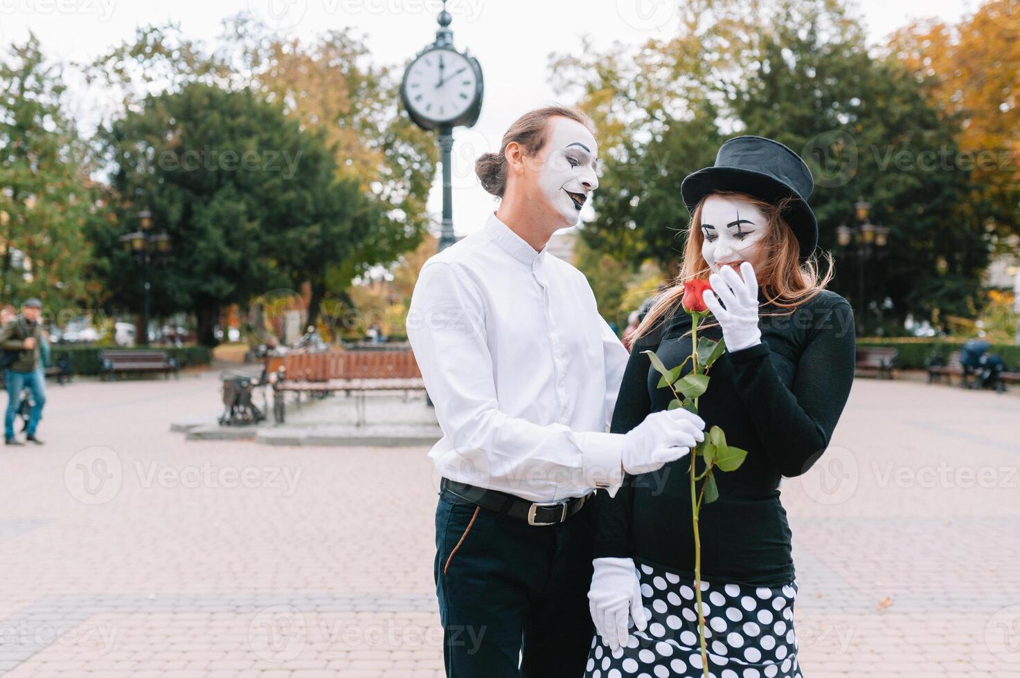A couple of merry mimes. He hurries on a date. photo