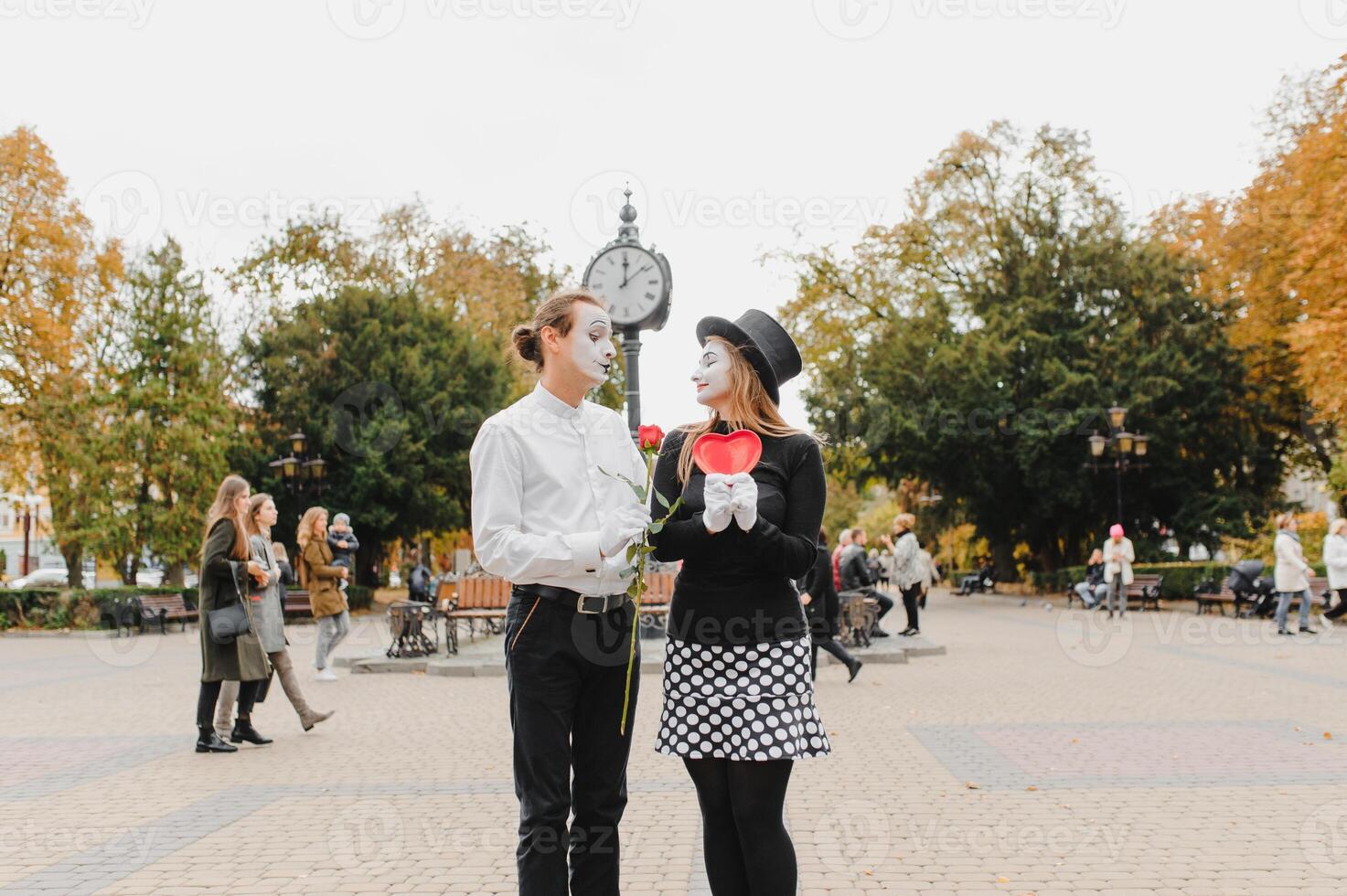 A couple of merry mimes. He hurries on a date. photo