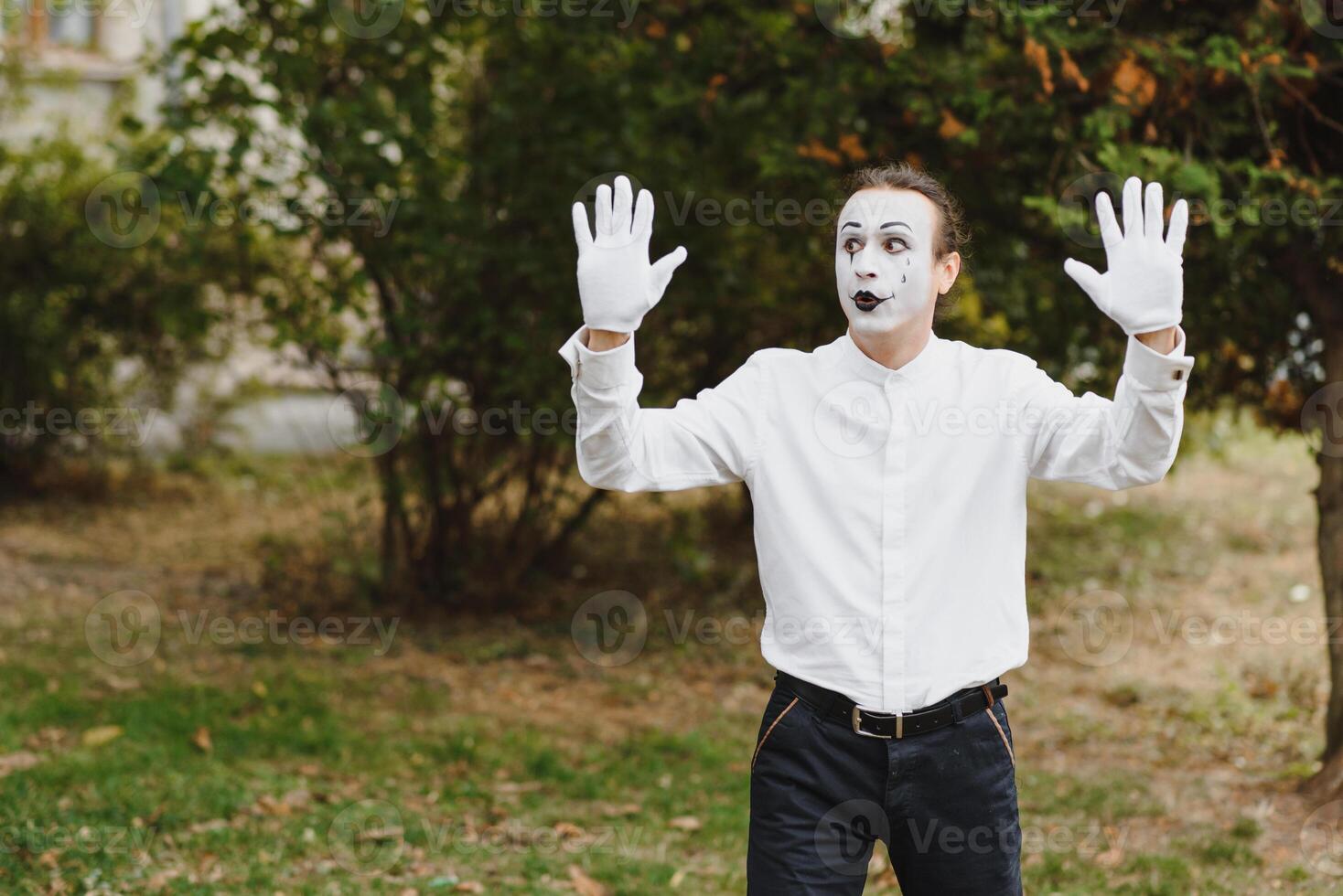 Portrait of a man, artist,clown, MIME. Shows something. Mime actor shows different emotions. photo