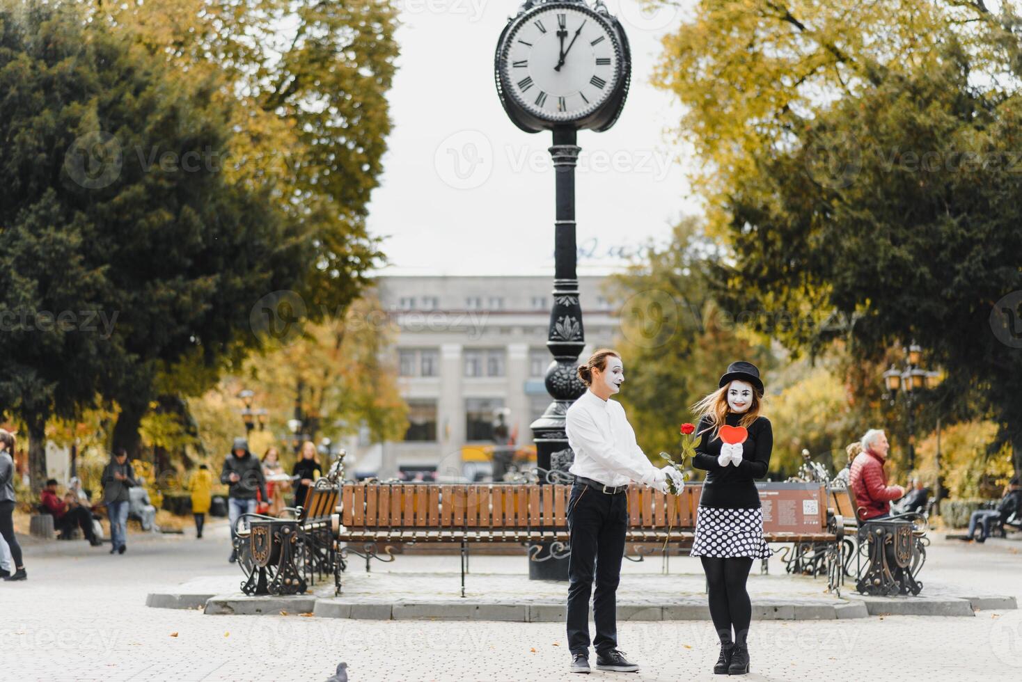 A couple of merry mimes. He hurries on a date. photo