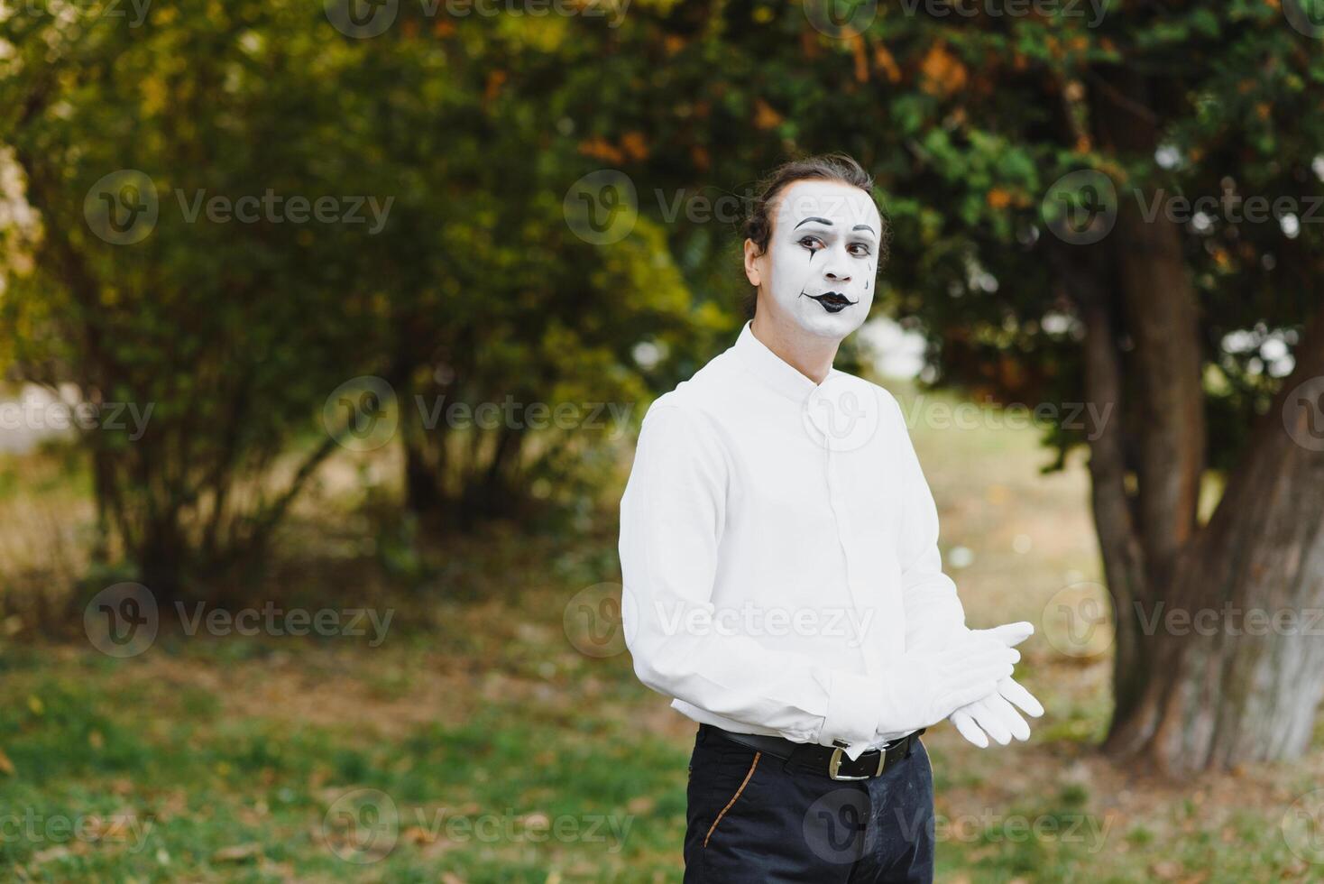 Portrait of a man, artist,clown, MIME. Shows something. Mime actor shows different emotions. photo