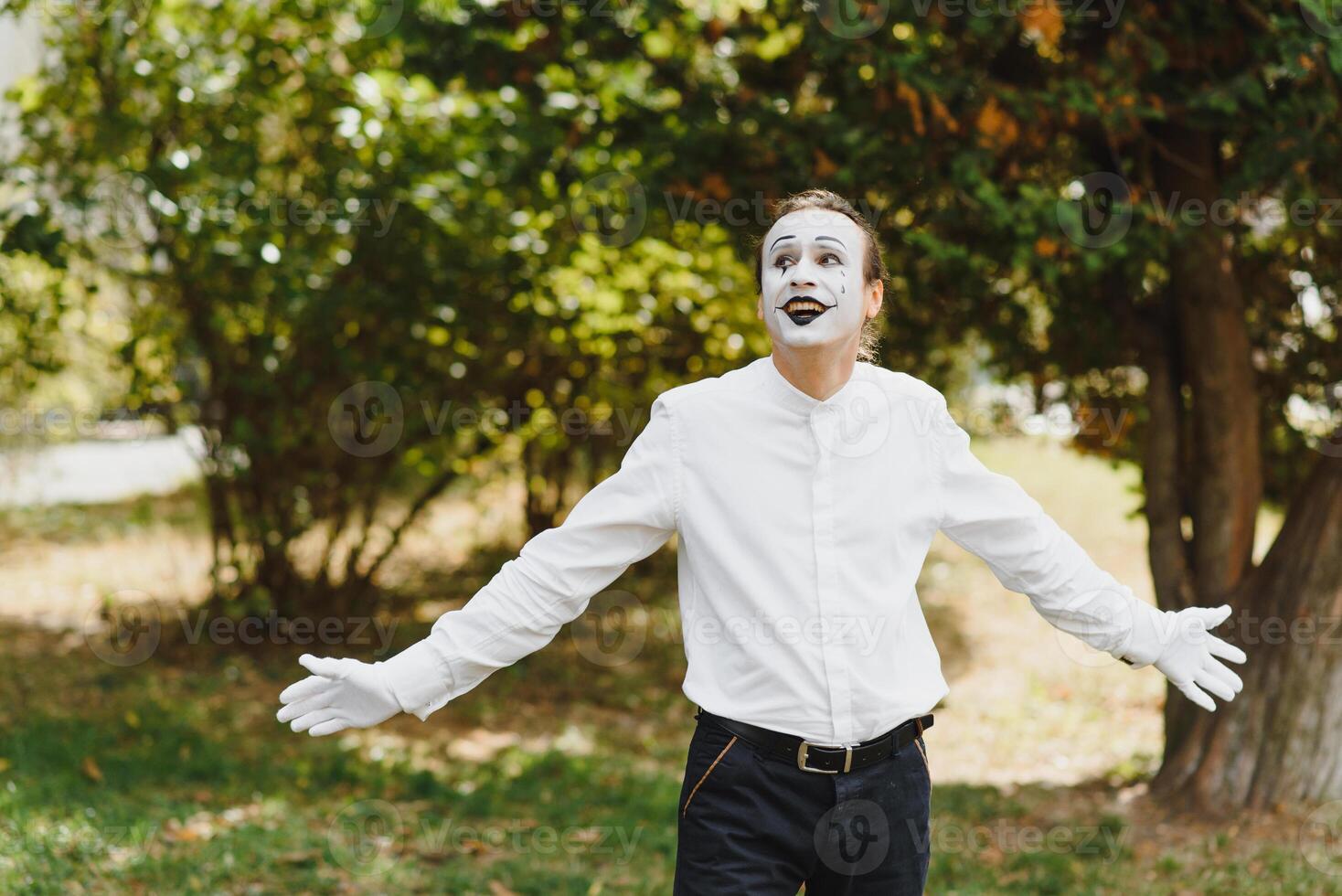 Portrait of a man, artist,clown, MIME. Shows something. Mime actor shows different emotions. photo