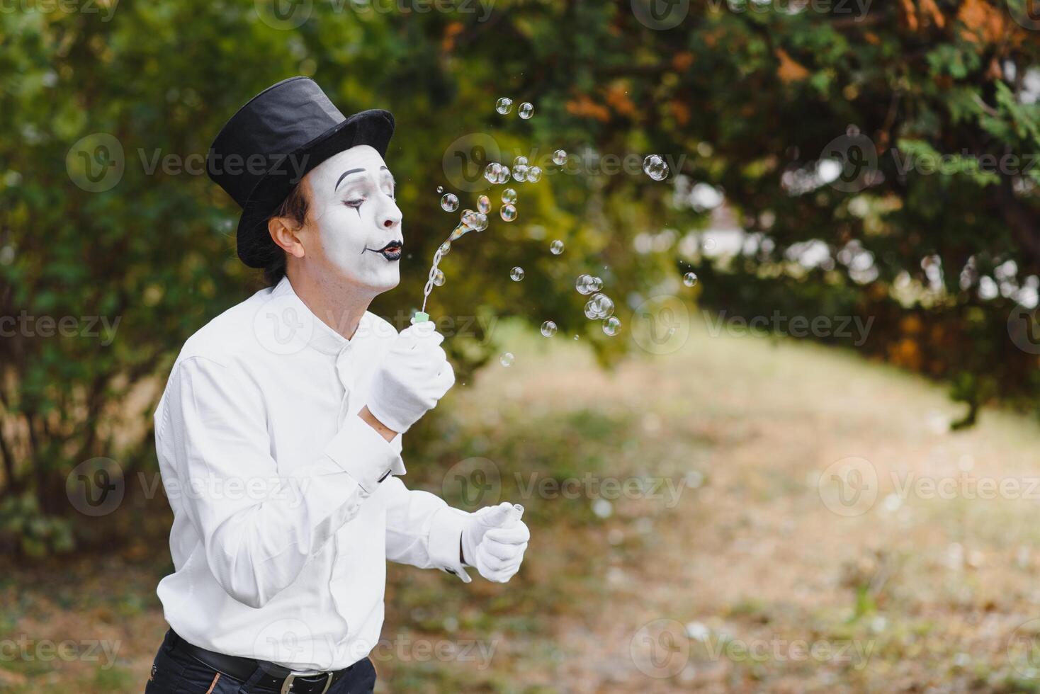 Mime artist blowing a bubble photo