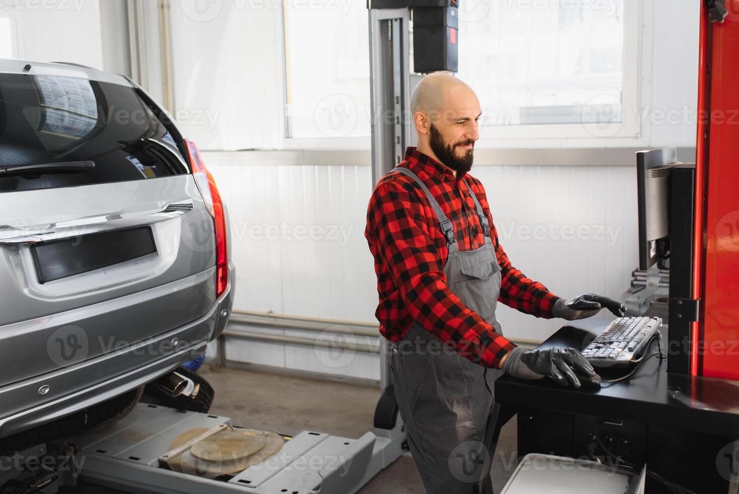 working process of a full system diagnostic scanner that can quickly test every system module s status and make faster diagnosis. mechanic makes computer diagnostics of the car photo