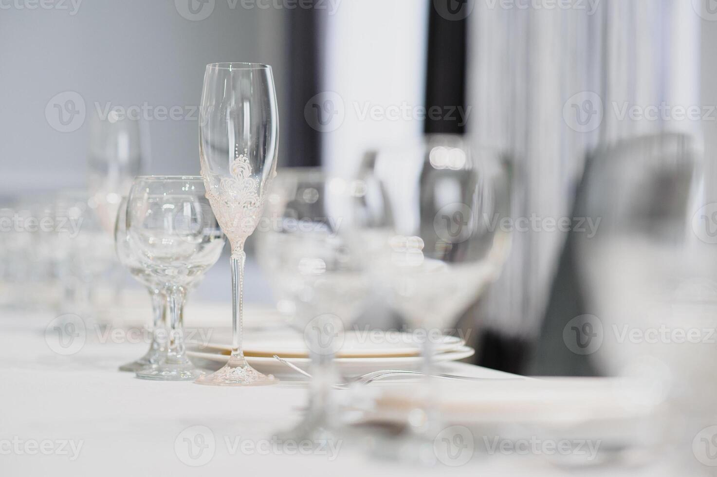 Glasses on the festive table setting. Wedding table decor concept. Table setting in classic style, setout. fine art. photo