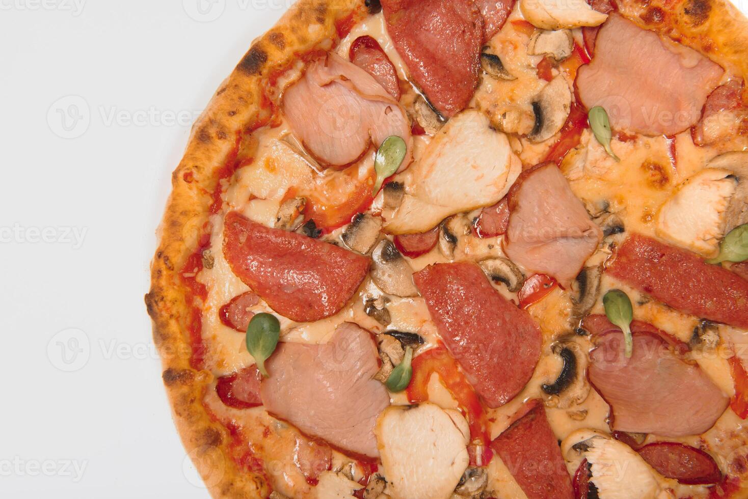 whole pizza with different meat toppings photo