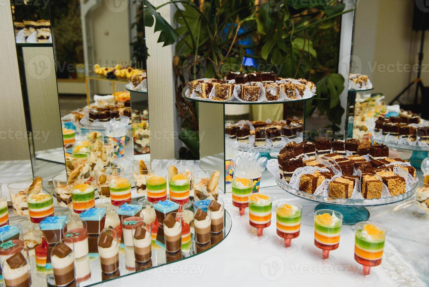 Delicious sweets on wedding candy buffet with desserts, cupcakes,tiramisu and cookies photo
