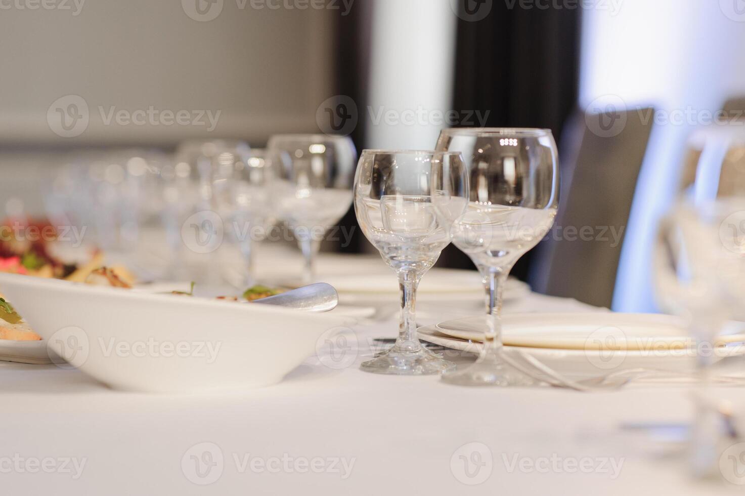 Glasses on the festive table setting. Wedding table decor concept. Table setting in classic style, setout. fine art. photo