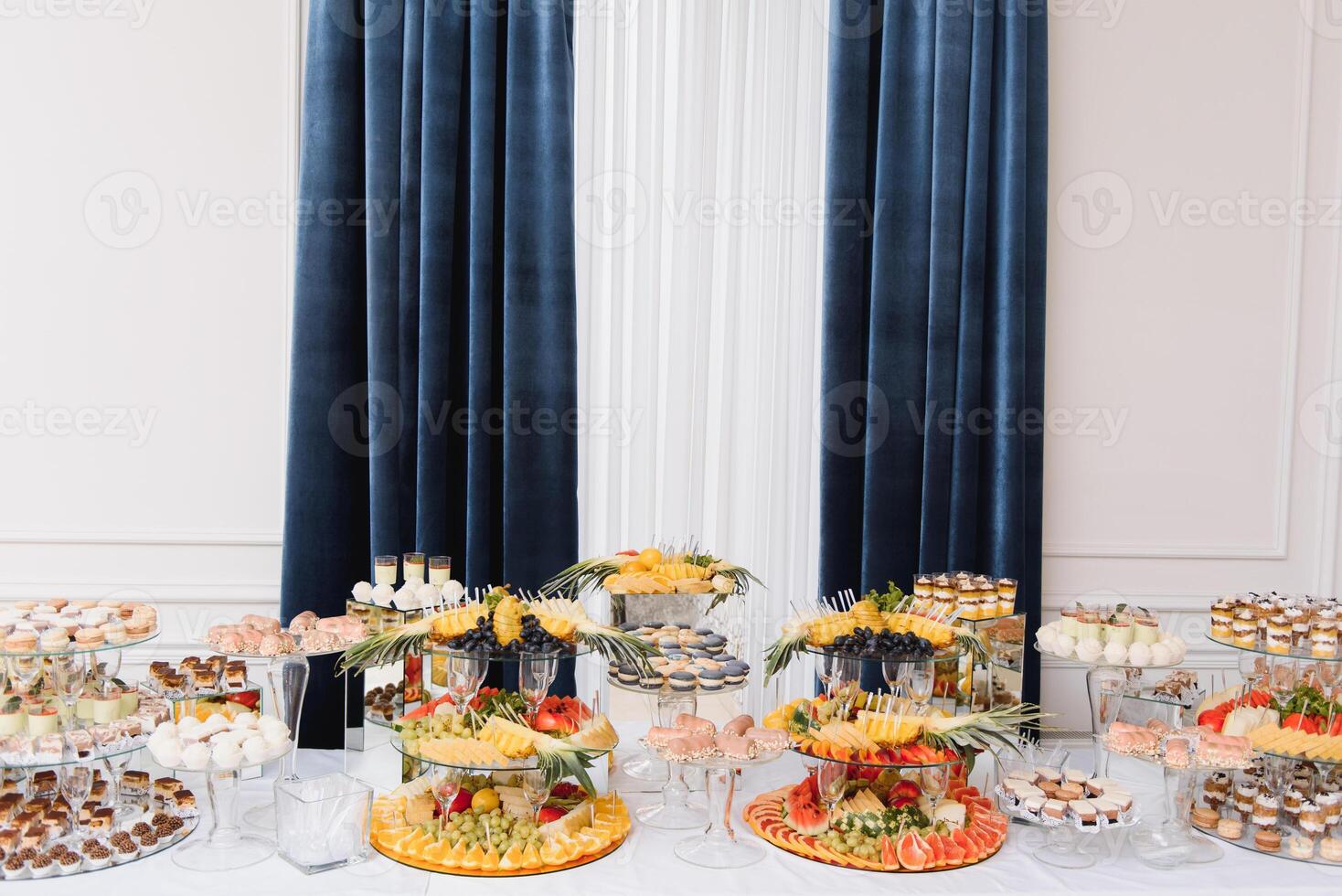 Delicious sweets on wedding candy buffet with desserts, cupcakes,tiramisu and cookies photo
