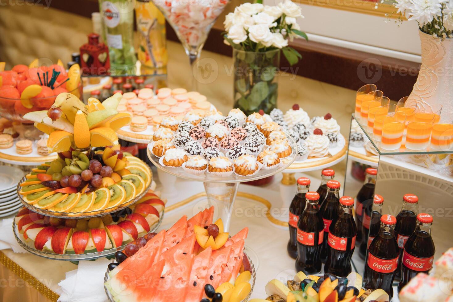 desserts with fruits, mousse, biscuits. Different types of sweet pastries, small colorful sweet cakes, macaron, and other desserts in the sweet buffet. candy bar for birthday photo