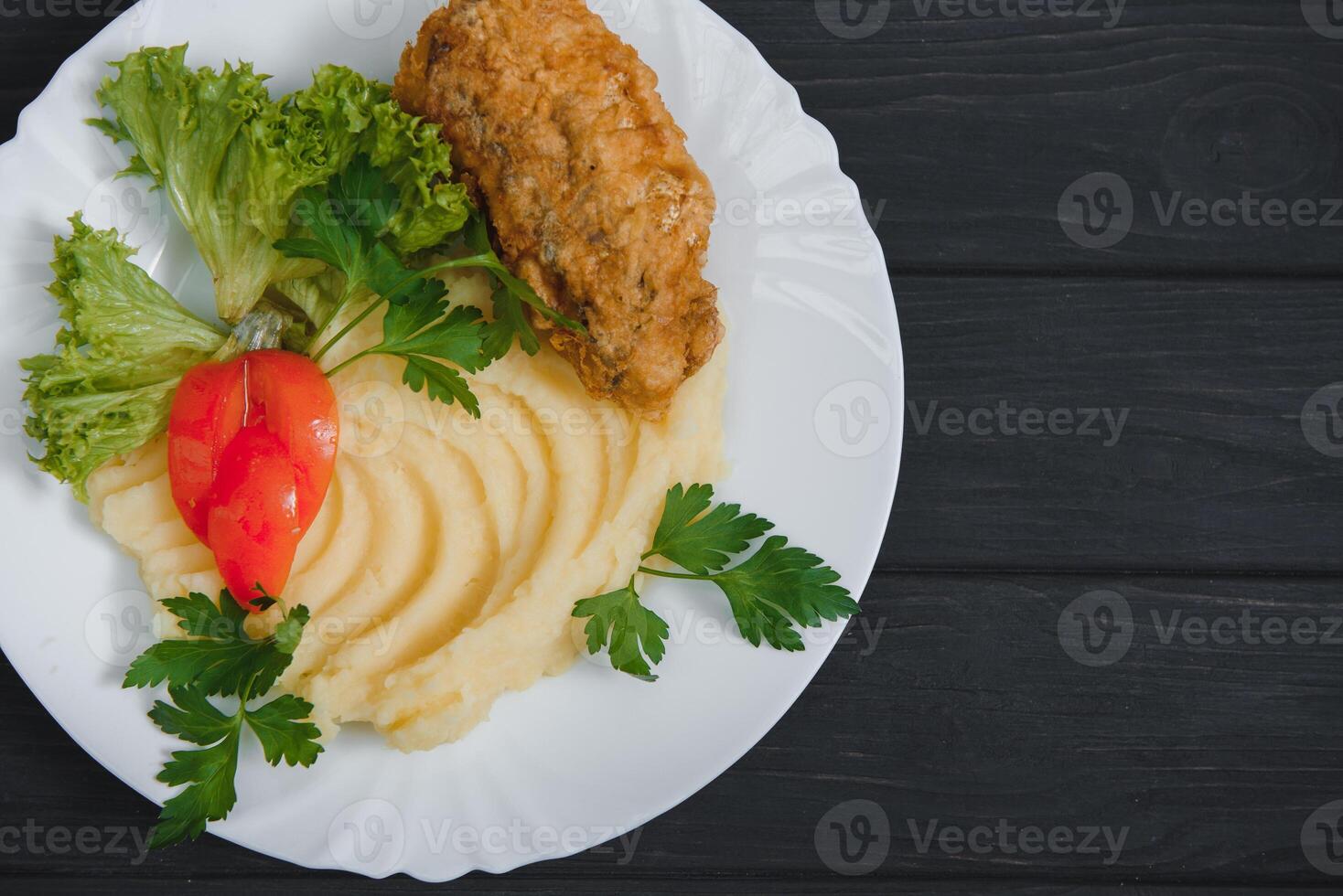mashed potatoes with meat and vegetables on wooden background photo