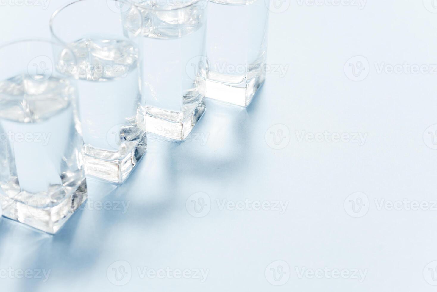 Water filters. Carbon cartridges and glasses on a blue background. Household filtration system. photo