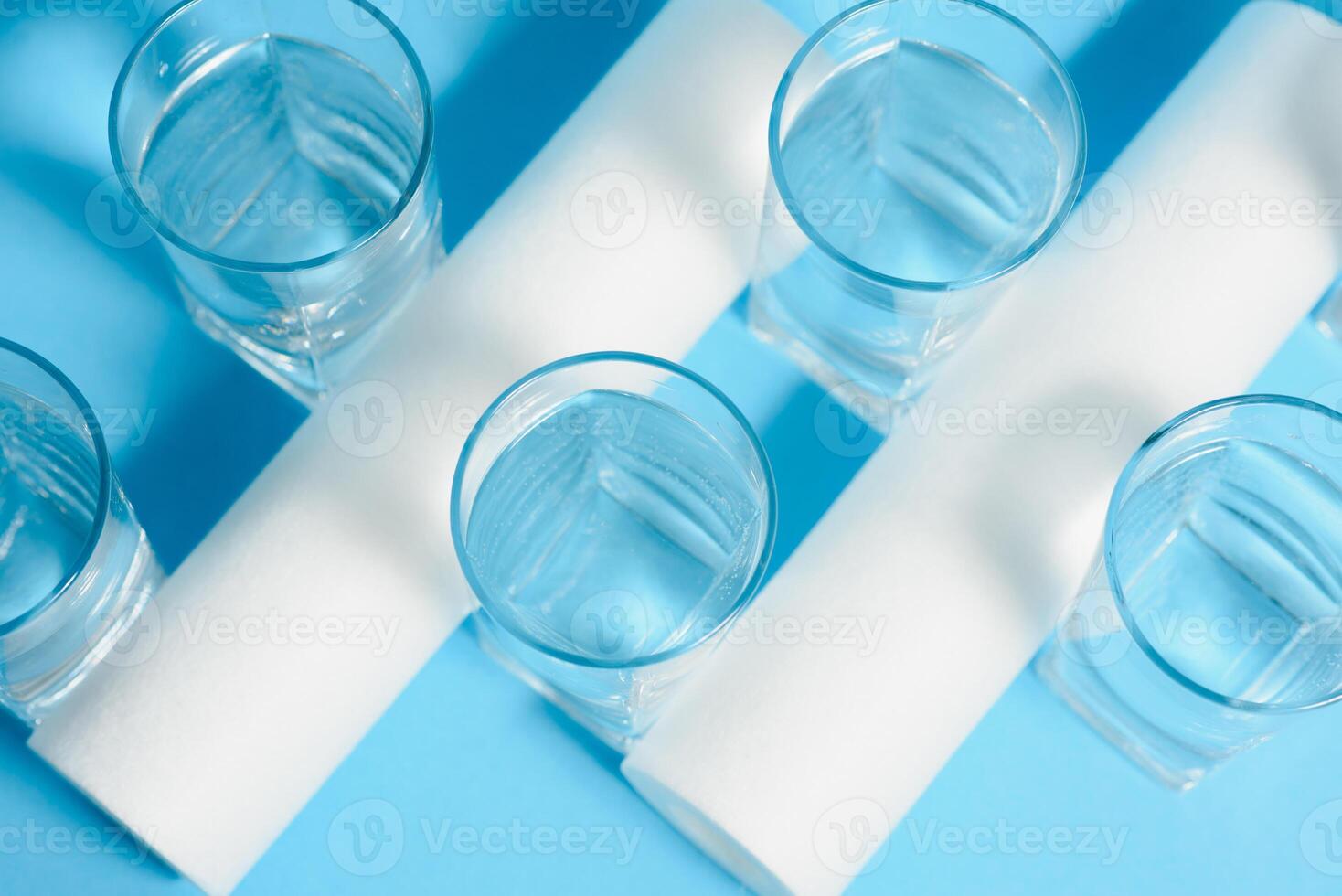 A glass of water on the background of filter cartridges photo