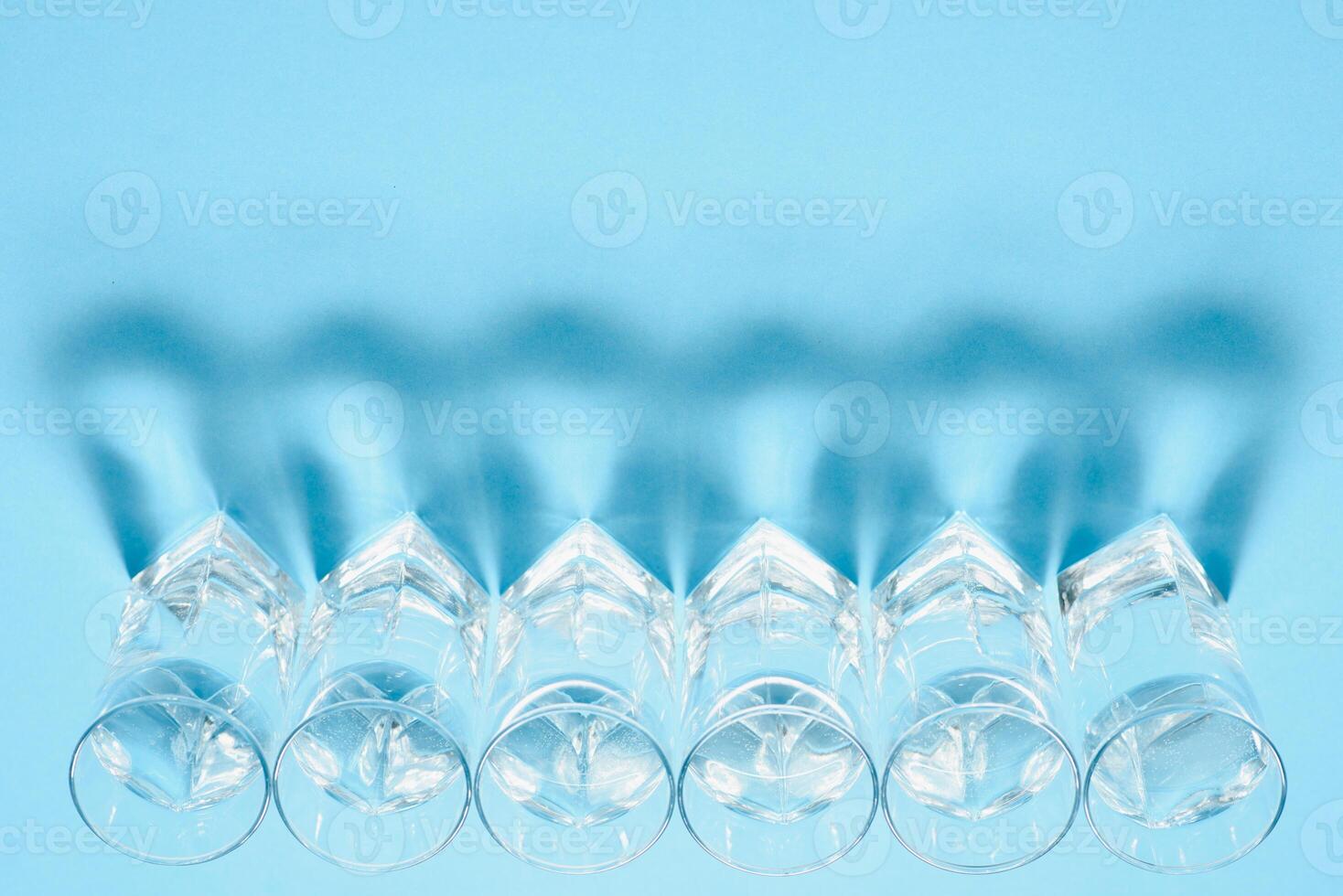 Glasses of water on blue. Close up. Copy space. Water balance for healthy and detox. photo