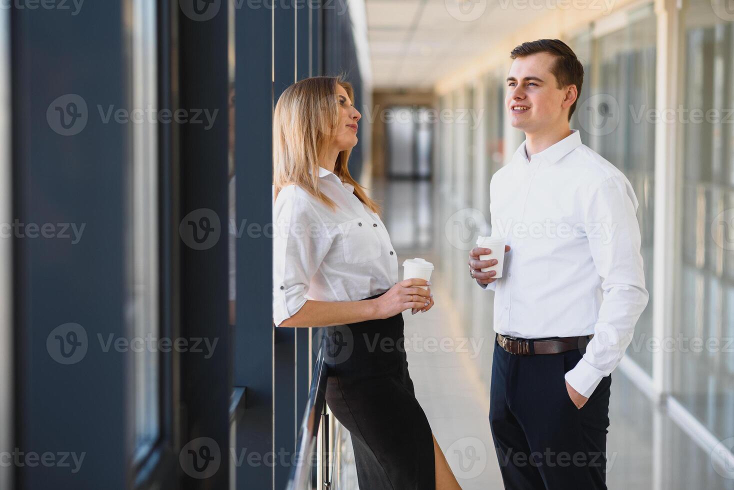 Smiling work team during break time in bright office photo