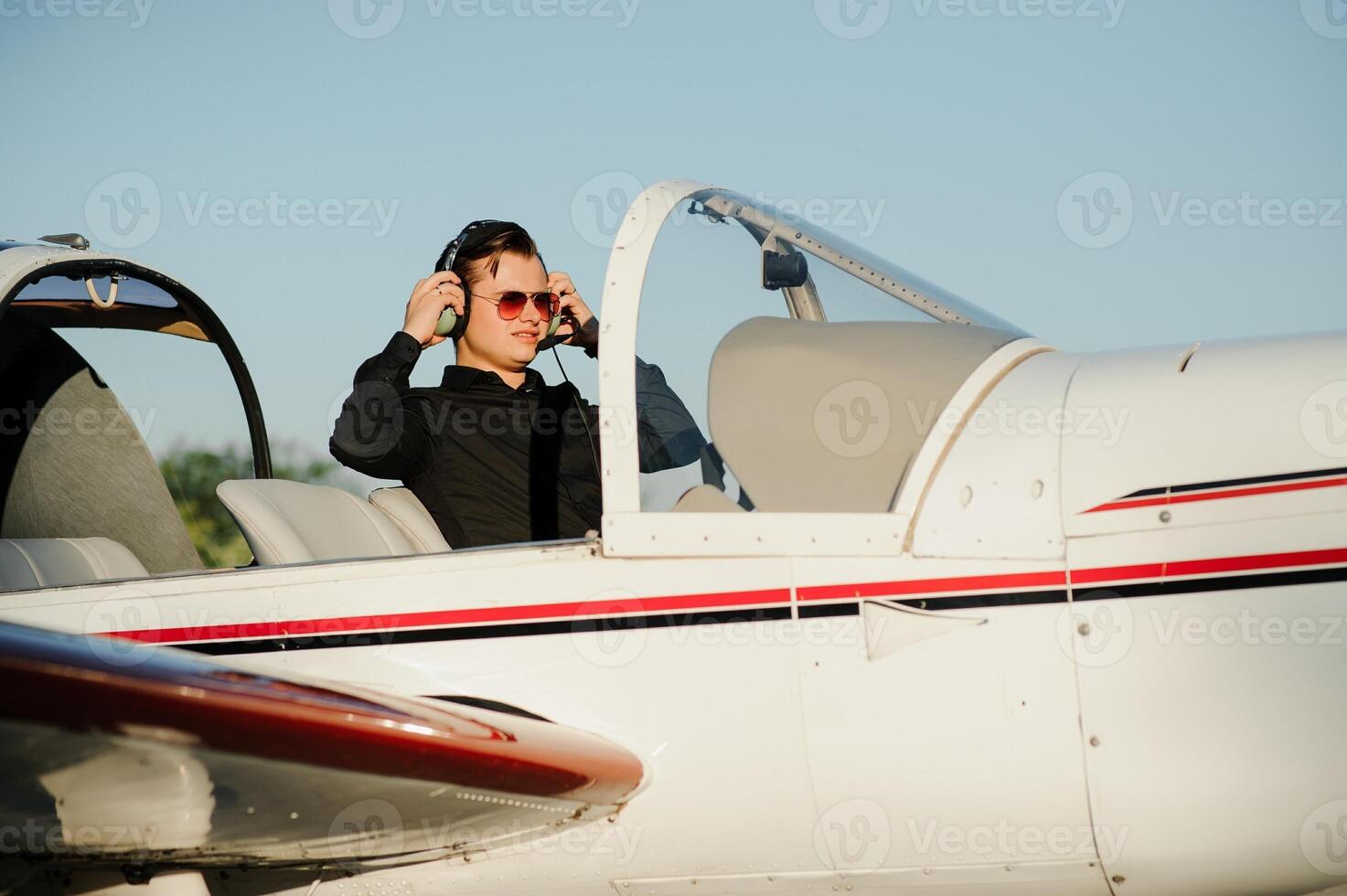 Young pilot is preparing for take off with private plane. photo