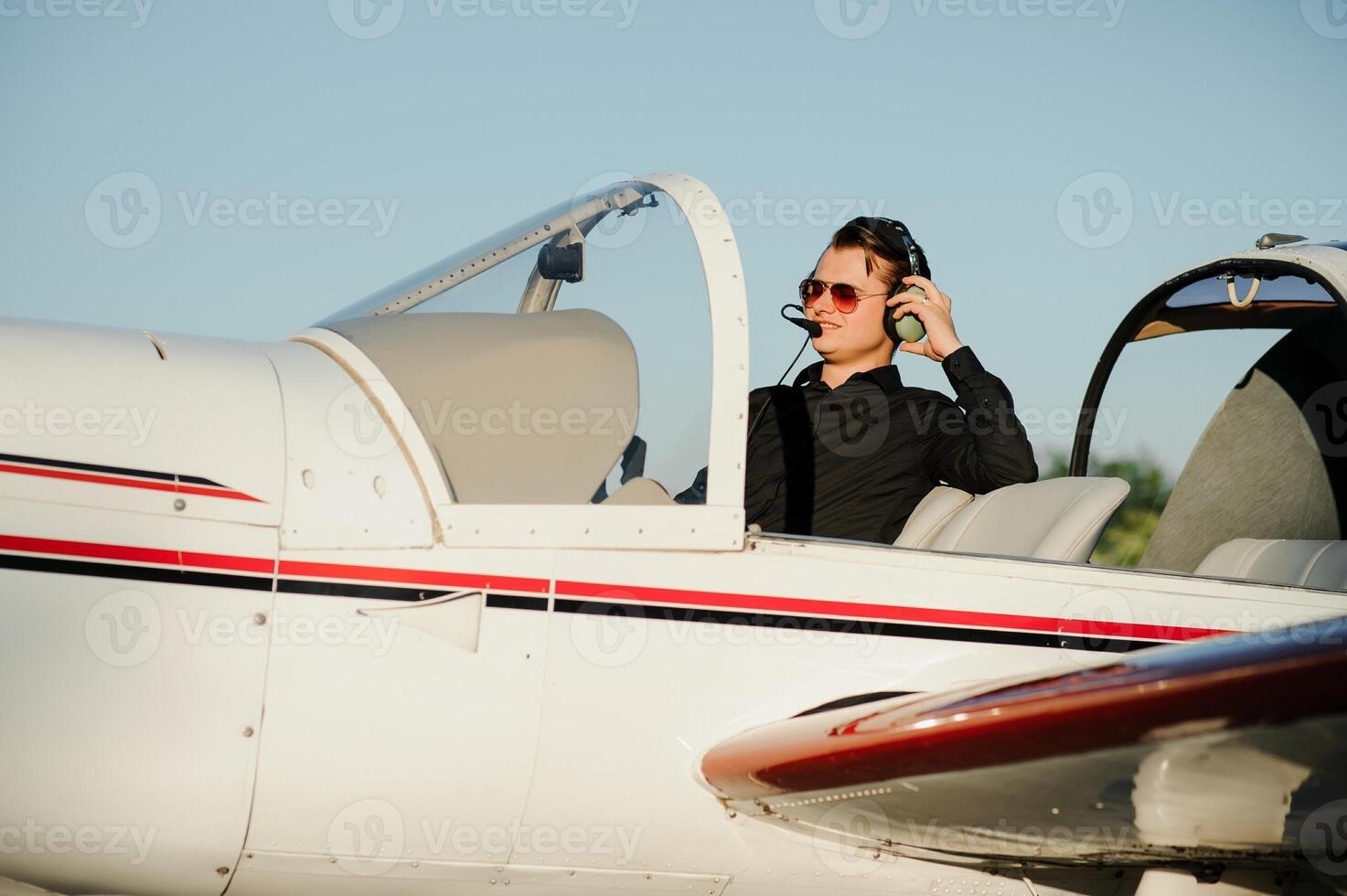Young pilot is preparing for take off with private plane. photo
