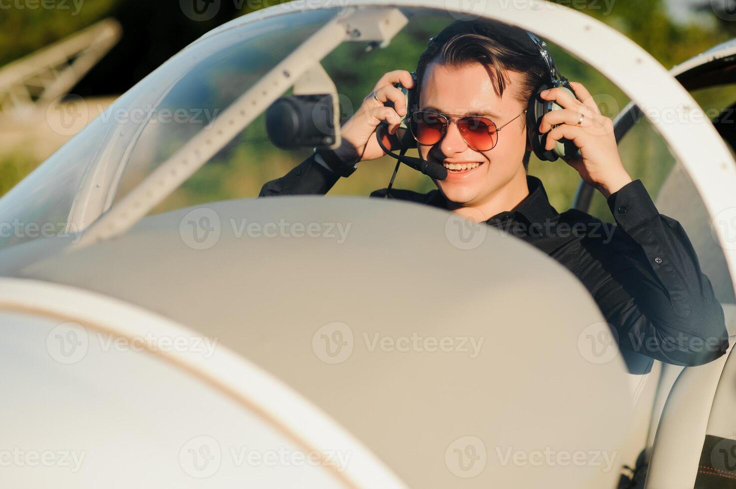 Young pilot is preparing for take off with private plane. photo