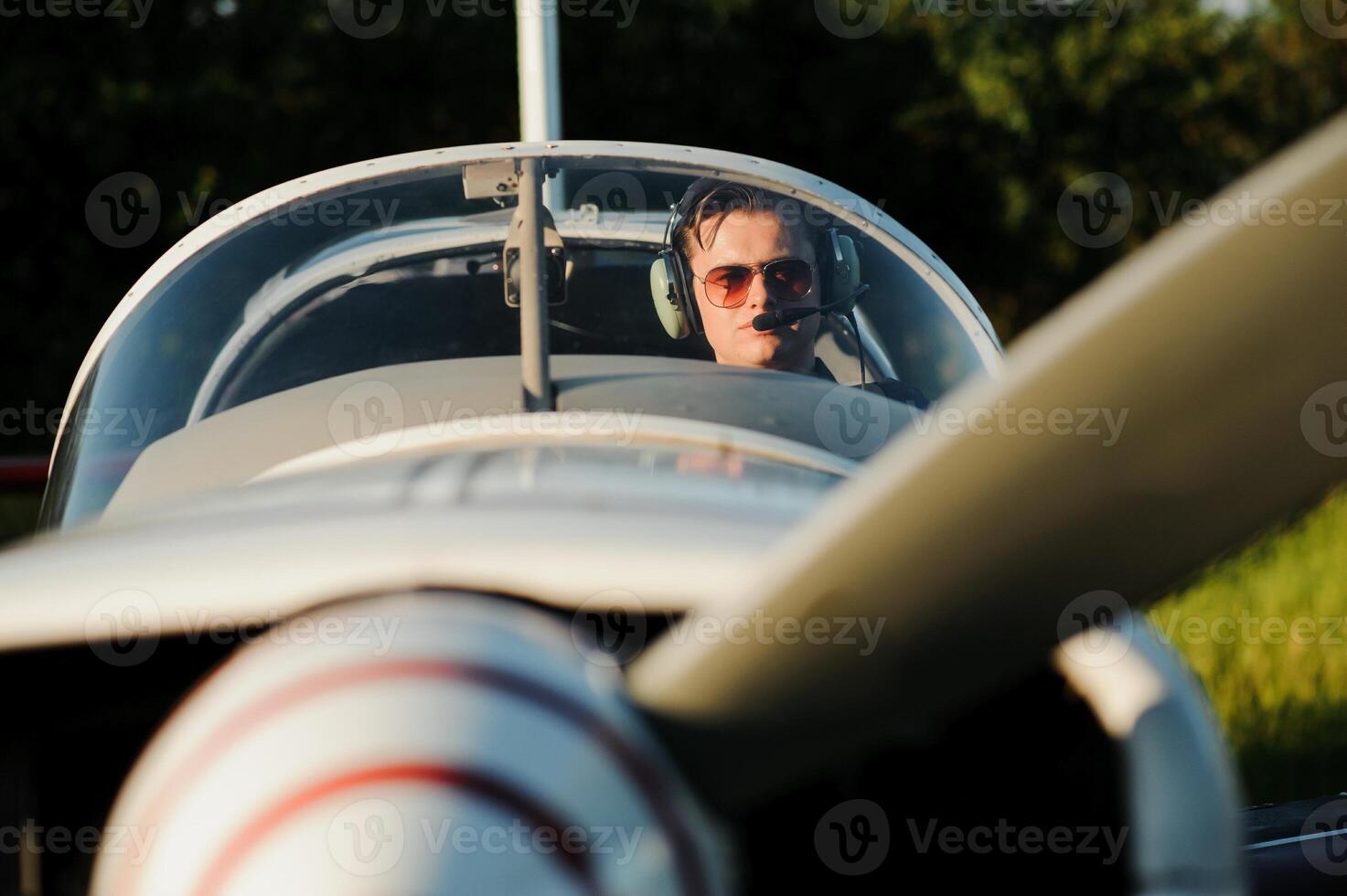 Young pilot is preparing for take off with private plane. photo