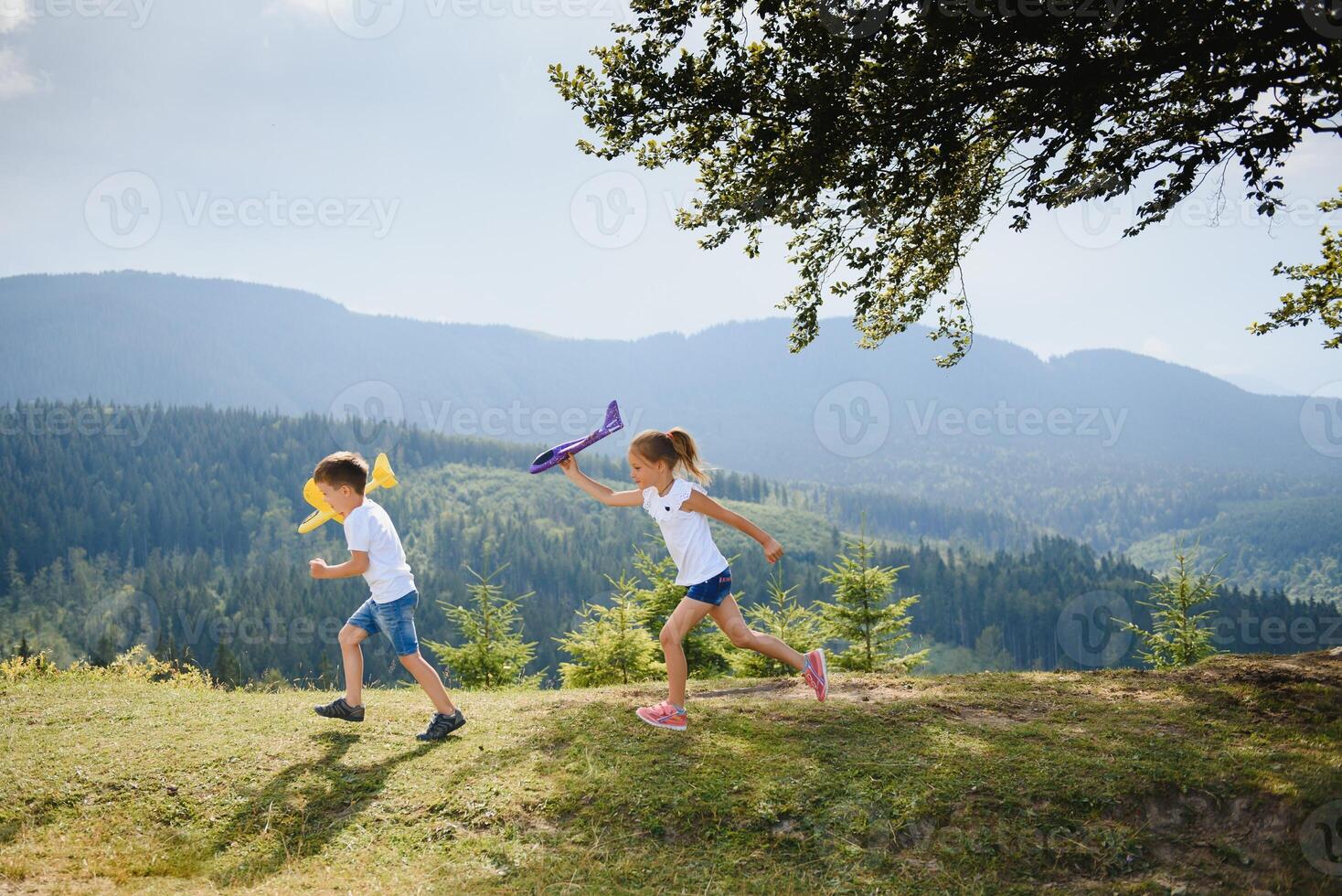 Children pilot aviator with airplane dreams of traveling in summer in nature. Vacation concept. photo