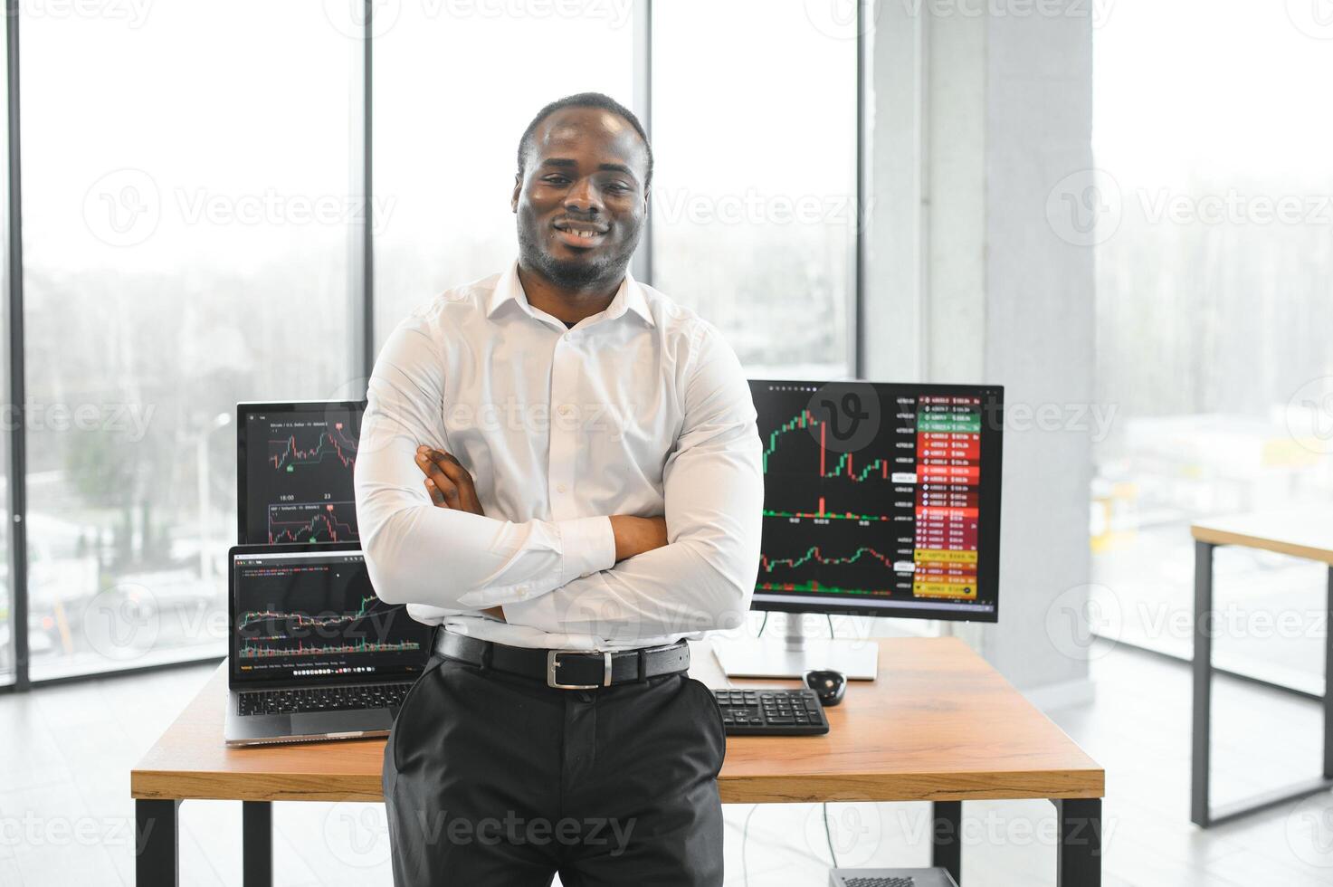 African-American broker works in office using workstation and analysis technology photo