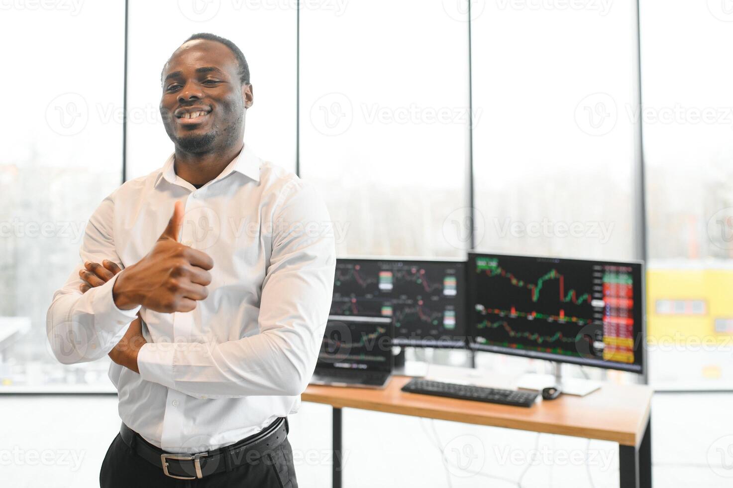 African-American broker works in office using workstation and analysis technology photo