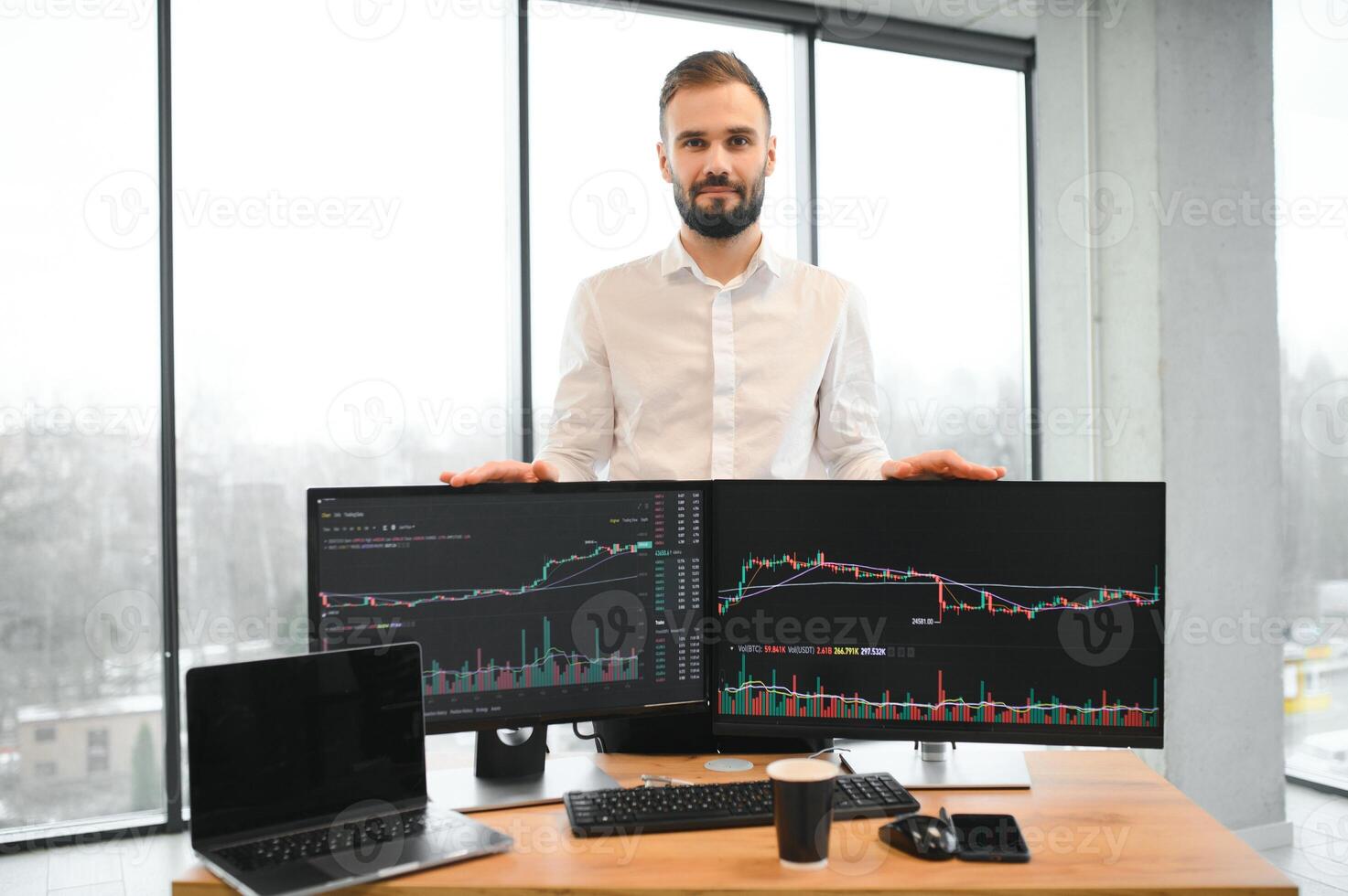 Crypto trader sits at his workplace in front of a monitor with charts. photo