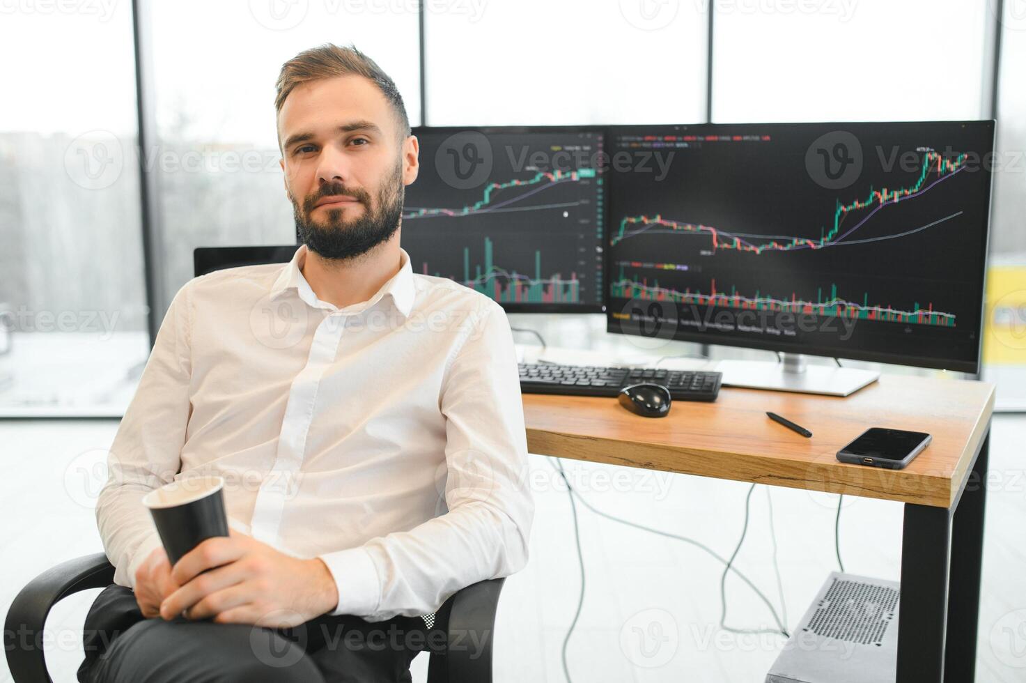 Crypto trader sits at his workplace in front of a monitor with charts. photo