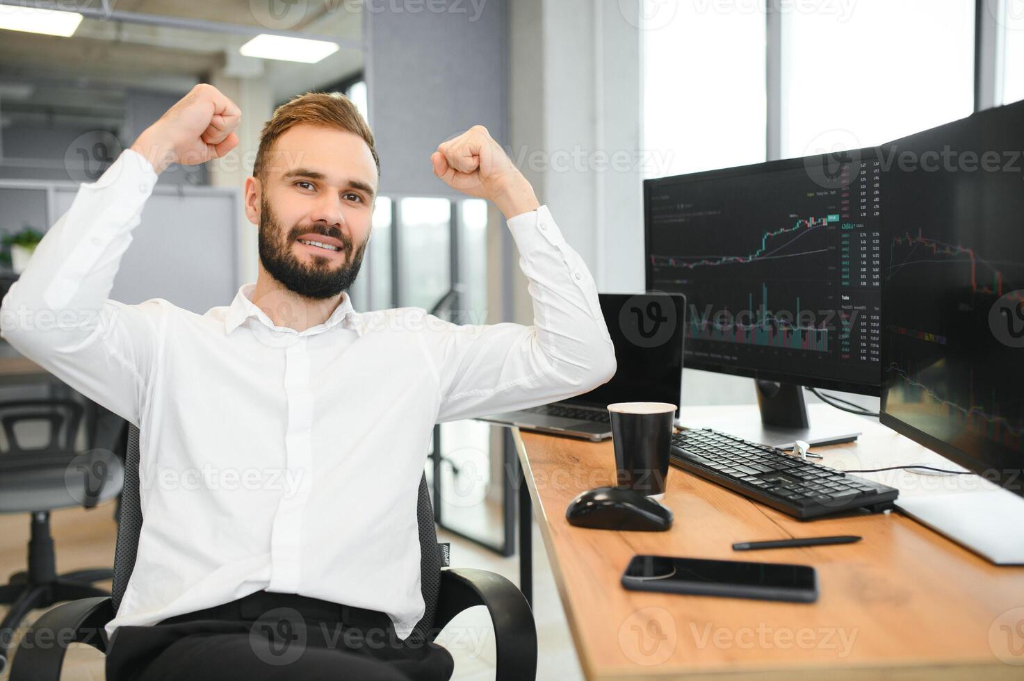 Crypto trader sits at his workplace in front of a monitor with charts. photo