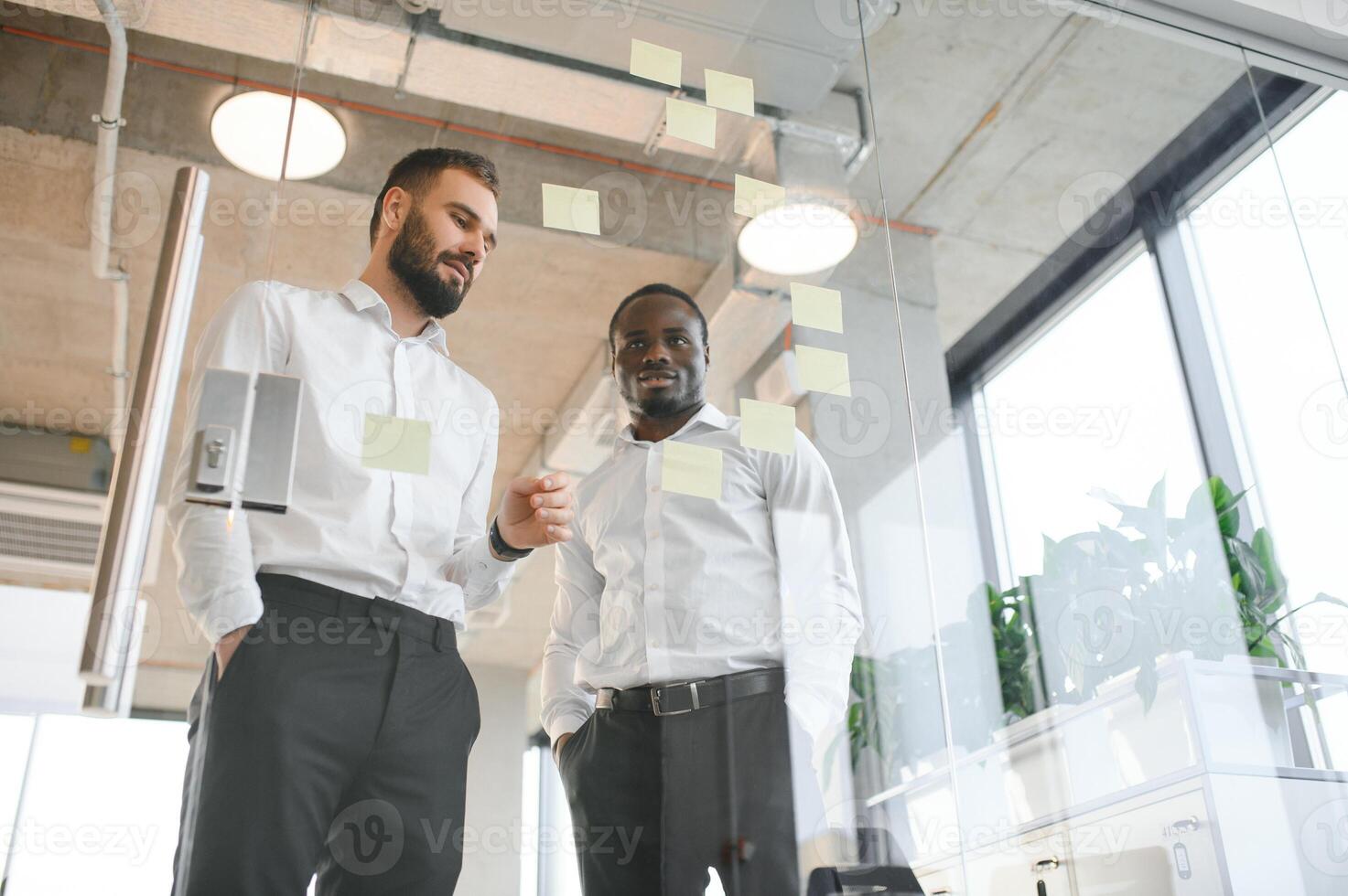 Young businessman manager writing strategy ideas on sticky notes. Business project planning. photo