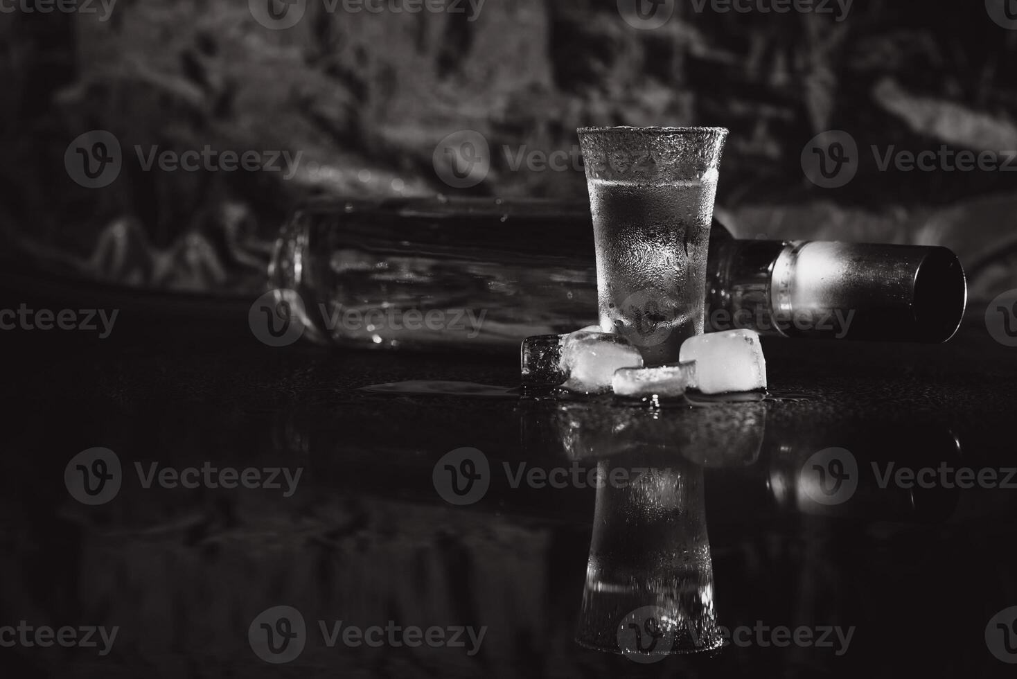Vodka. Shots, glasses with vodka with ice .Dark background. Copy space .Selective focus. photo