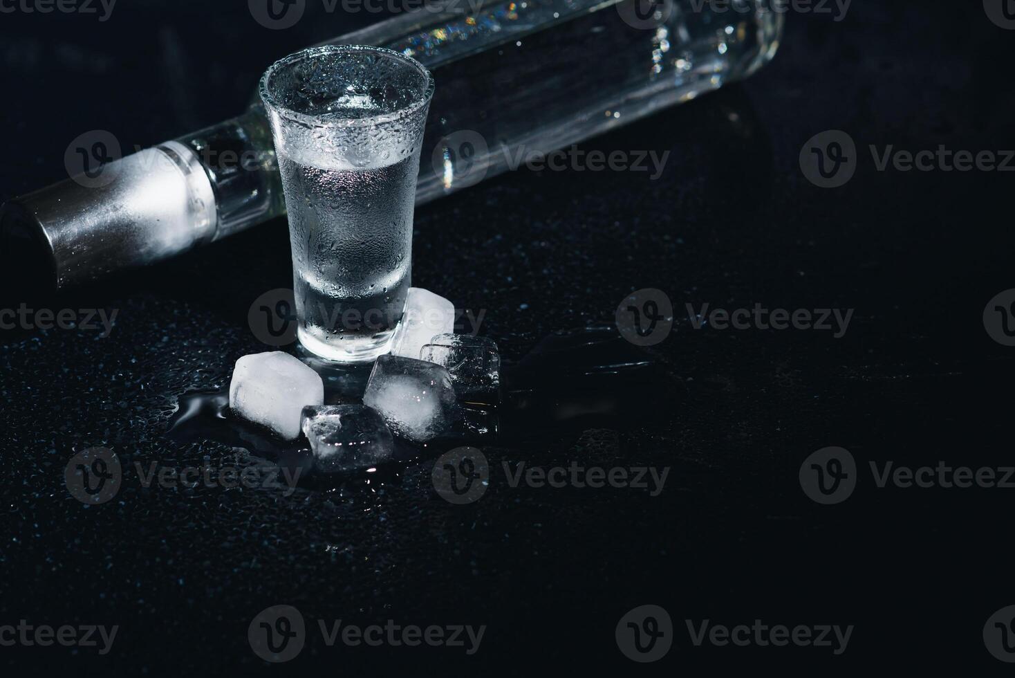Vodka. Shots, glasses with vodka with ice .Dark background. Copy space .Selective focus. photo