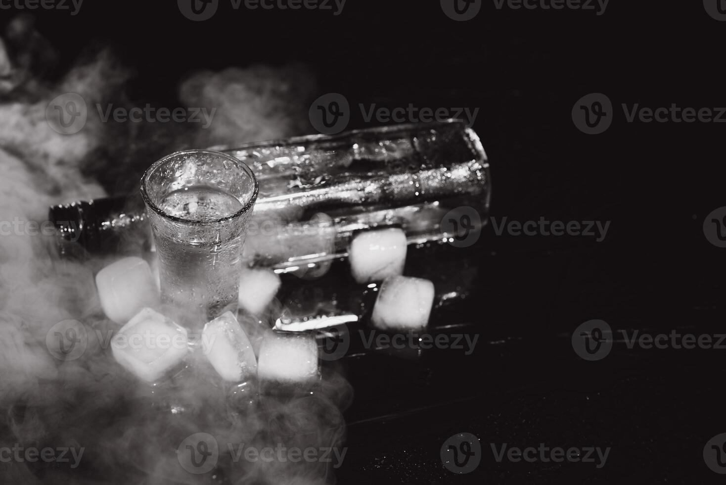 Vodka. Shots, glasses with vodka with ice .Dark background. Copy space .Selective focus. photo