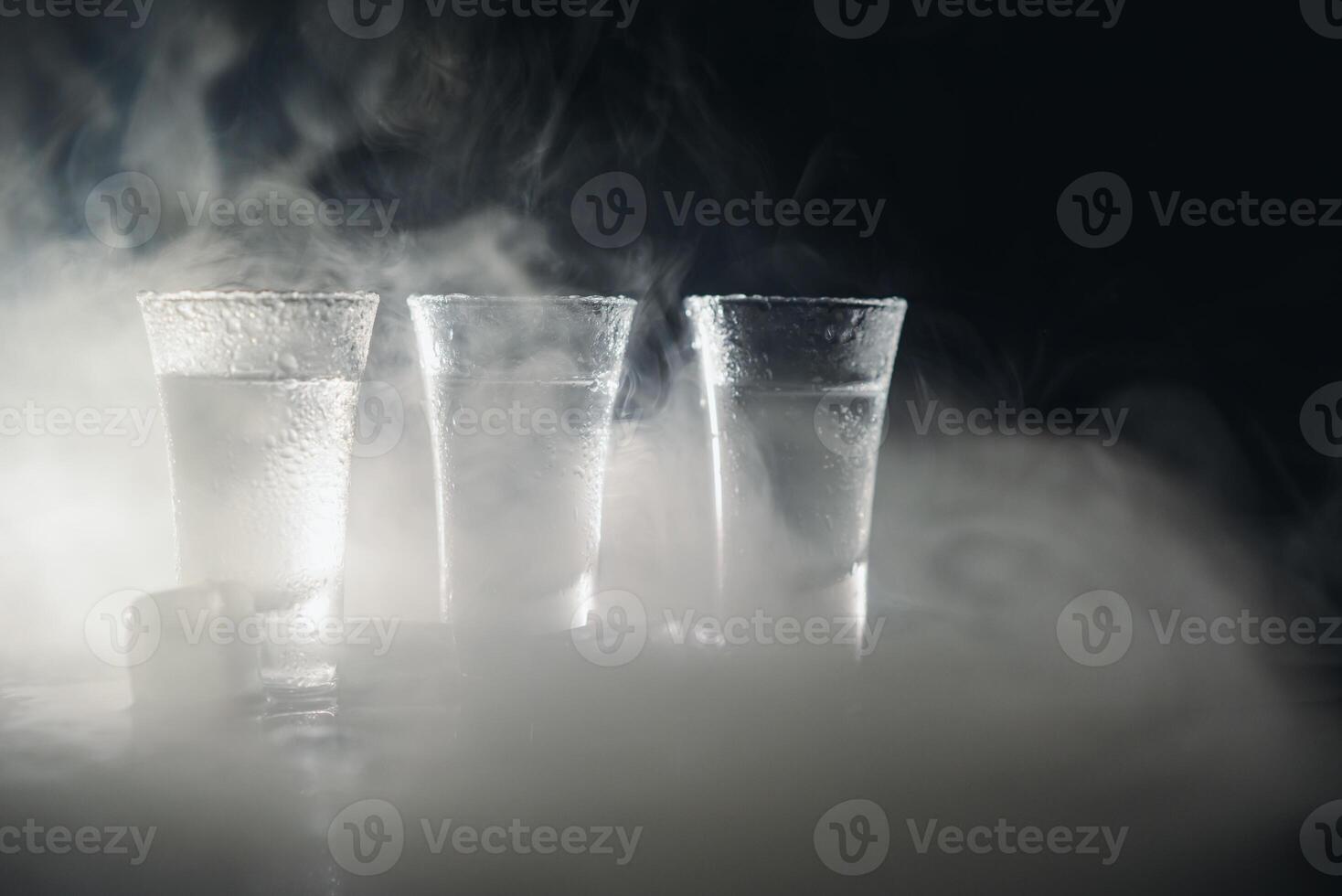 Vodka. Shots, glasses with vodka with ice .Dark background. Copy space .Selective focus. photo