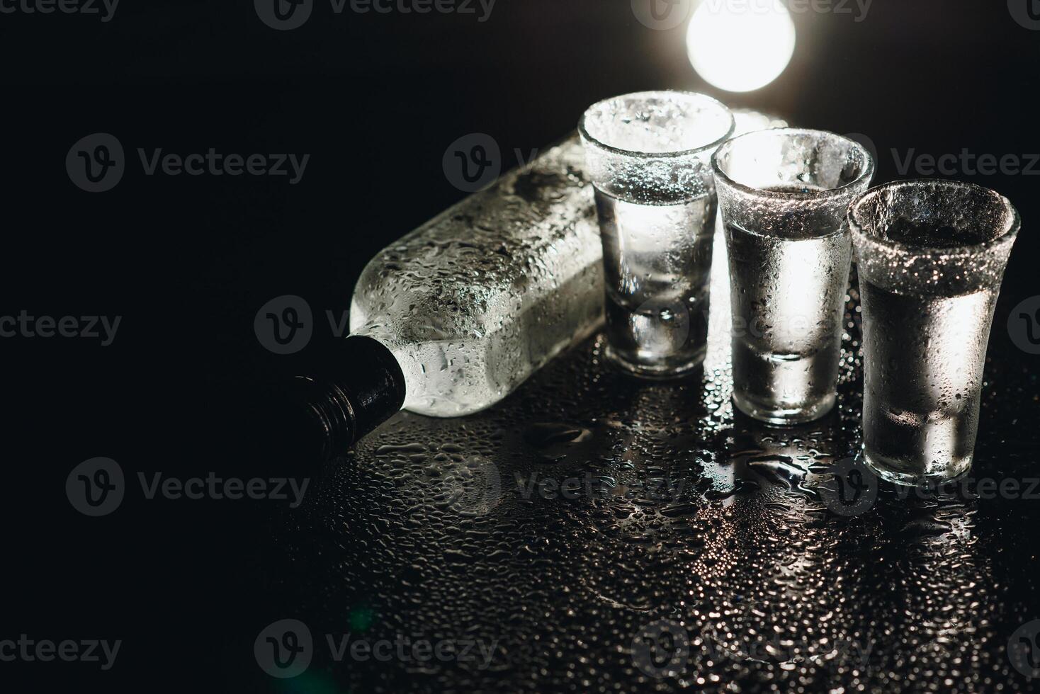 Vodka. Shots, glasses with vodka with ice .Dark background. Copy space .Selective focus. photo