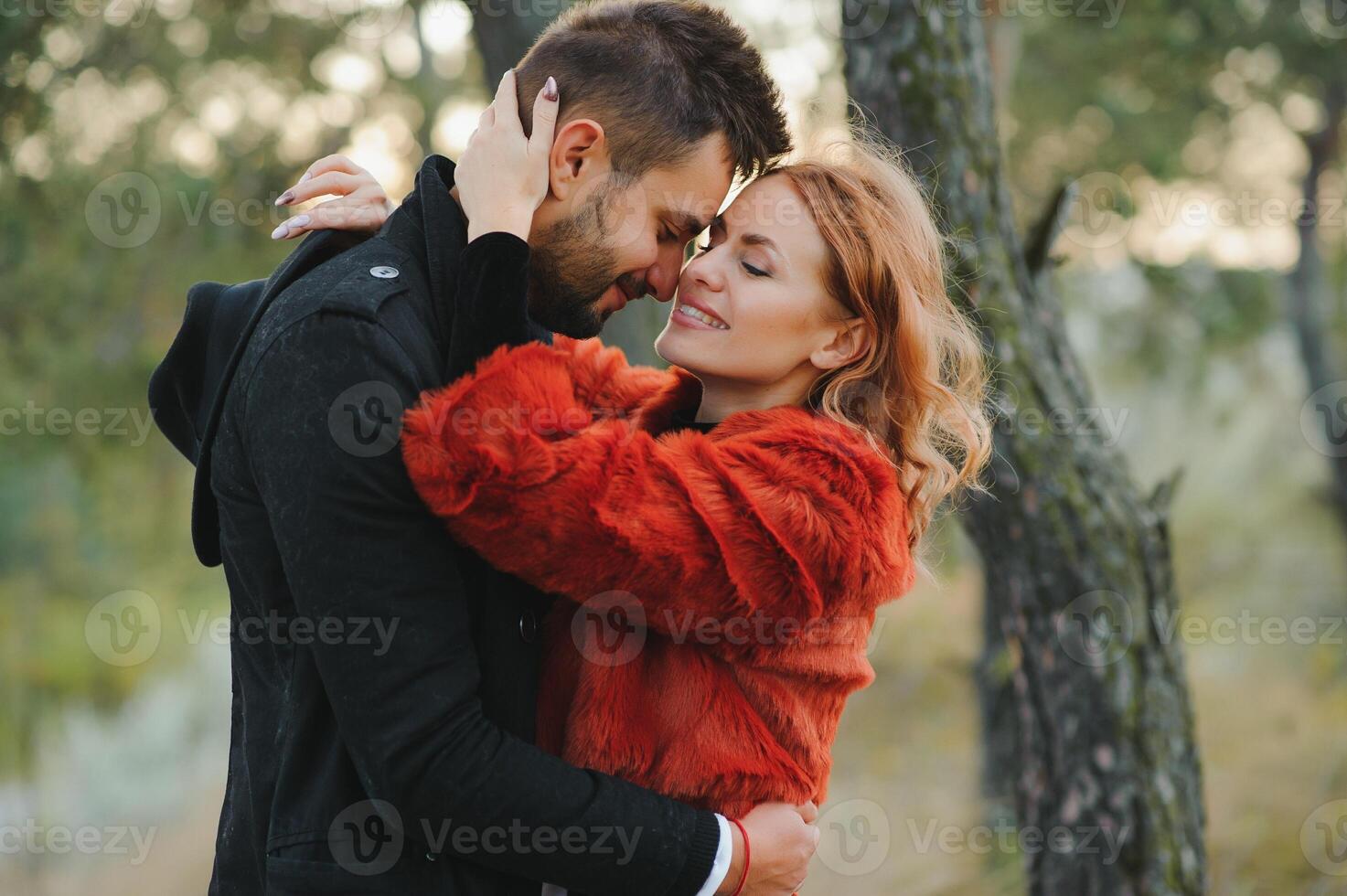 Kissing young couple in love in the autumn park. photo