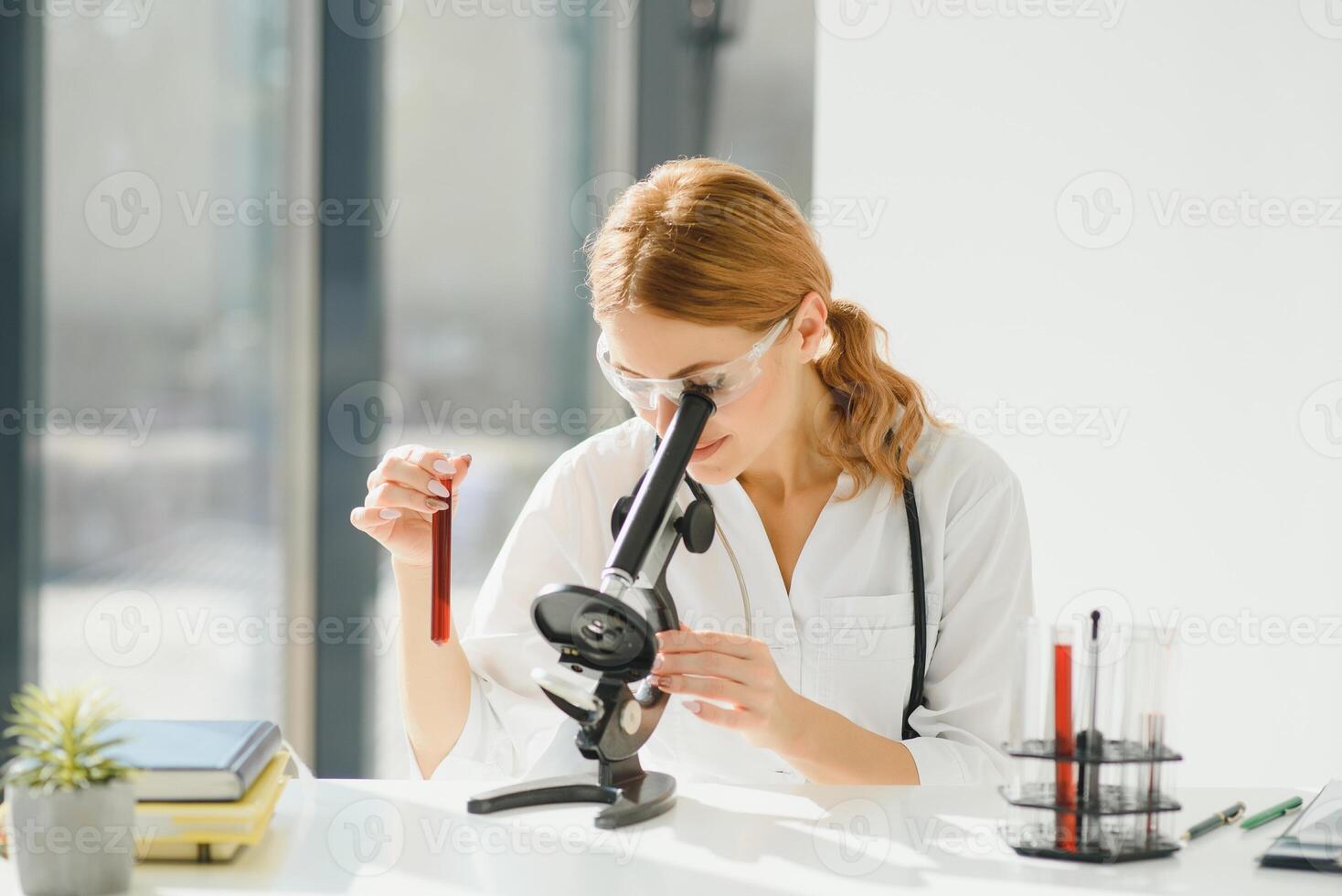 Doctor woman working a microscope. Female scientist looking through a microscope in lab. Student looking in a microscope, science laboratory concept photo