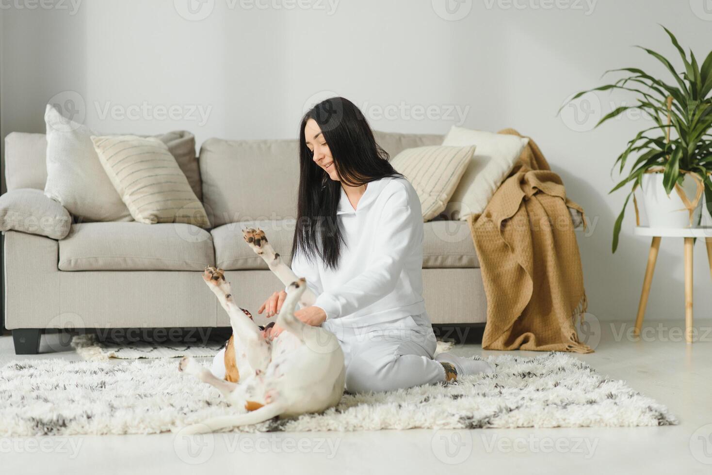 Portrait of happy woman with her dog at home. photo