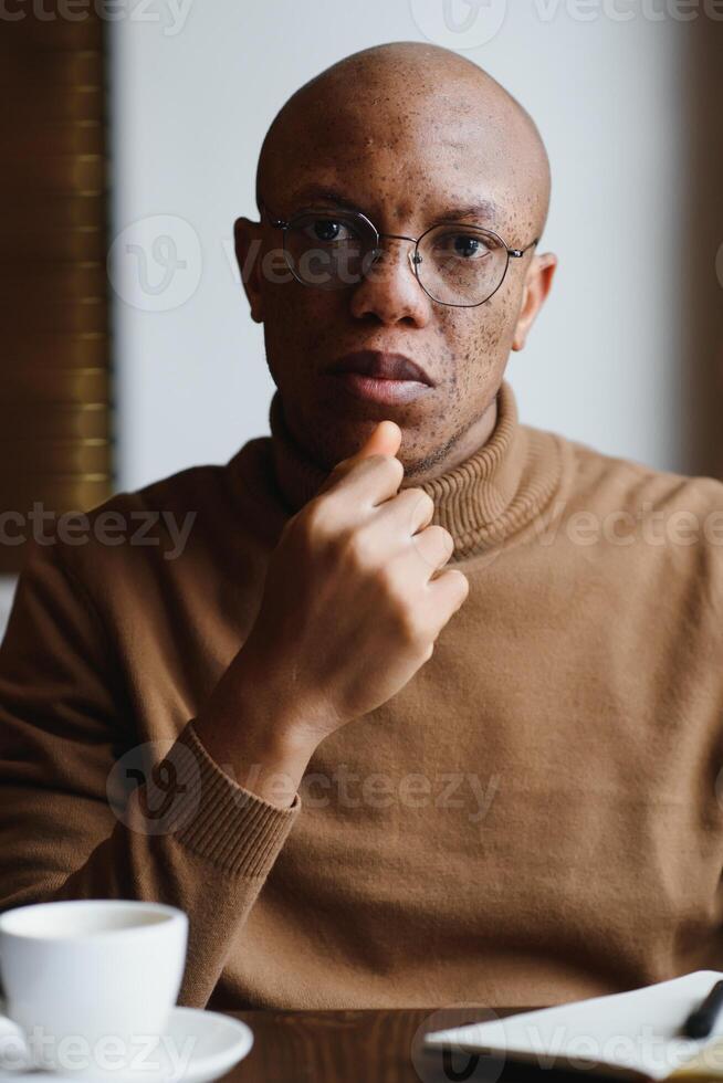 portrait of a serious african american man with glasses photo