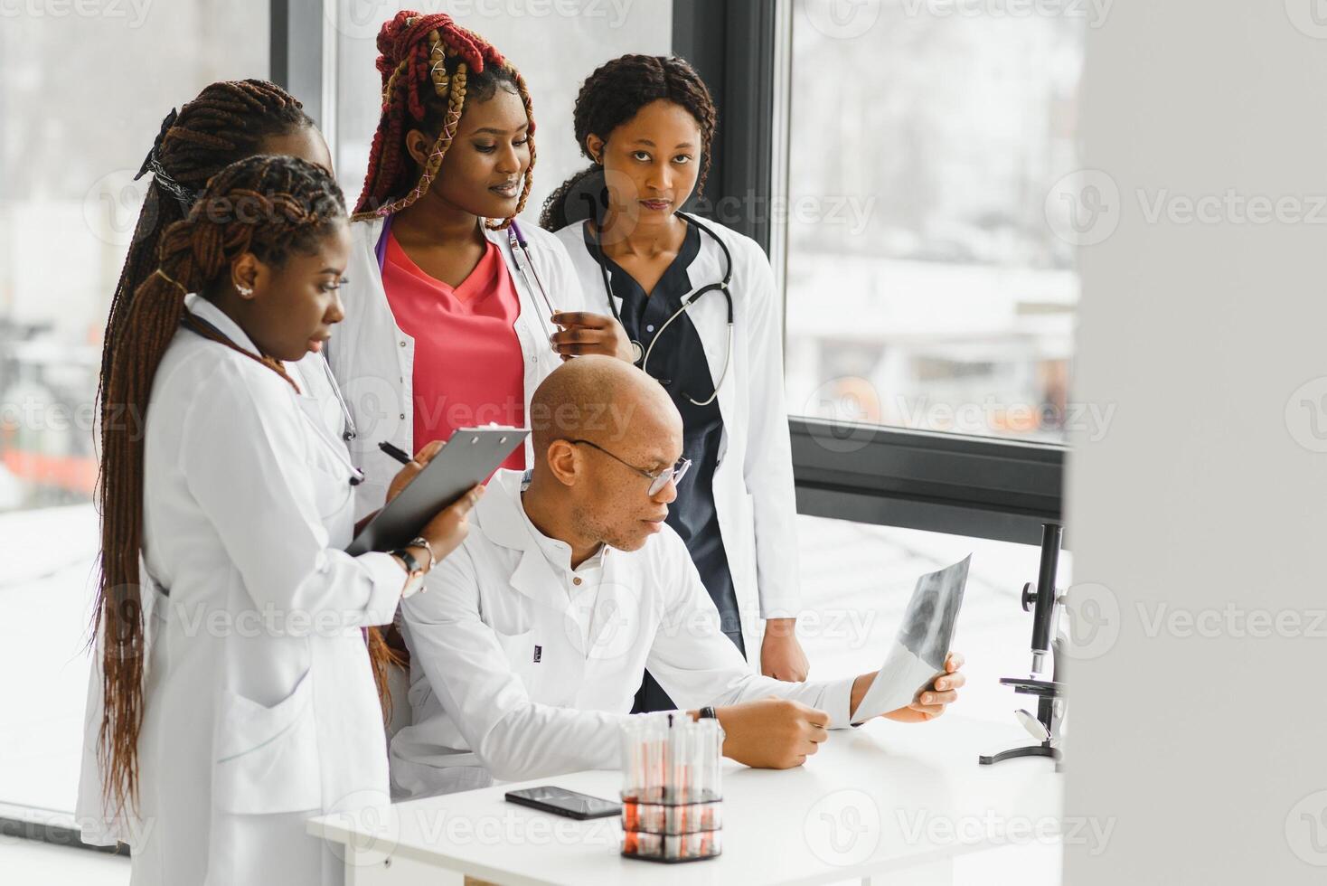 group of young african medical workers on white background. photo