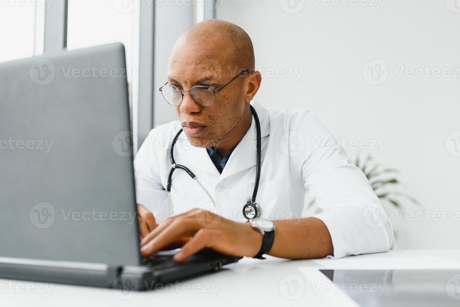 African American man male hospital doctor in white coat with stethoscope. photo