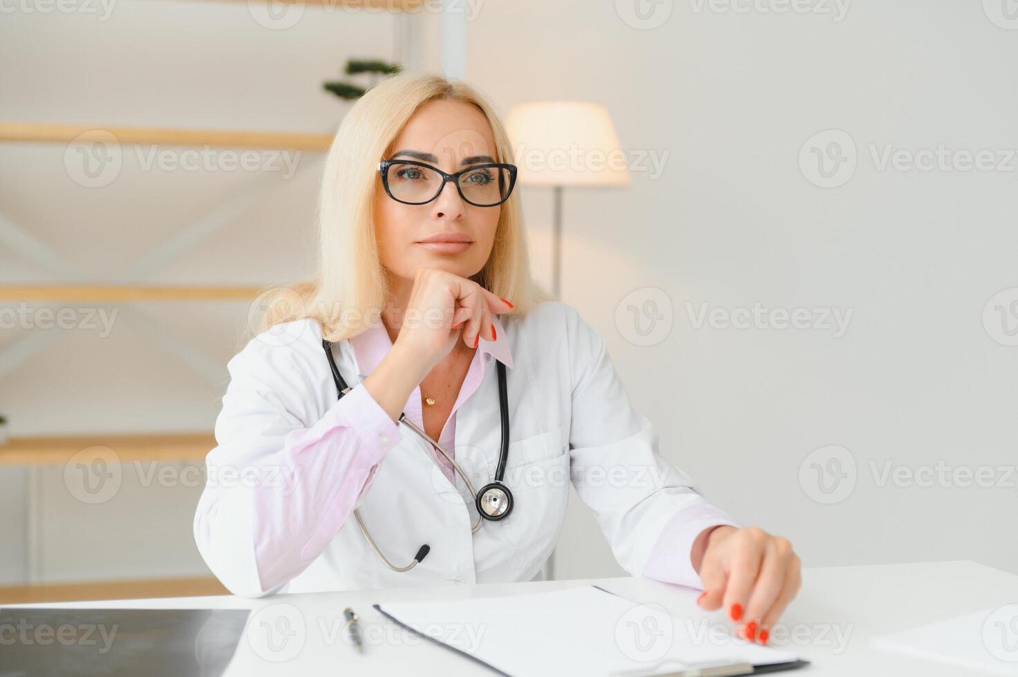 Middle age woman wearing doctor uniform at clinic photo