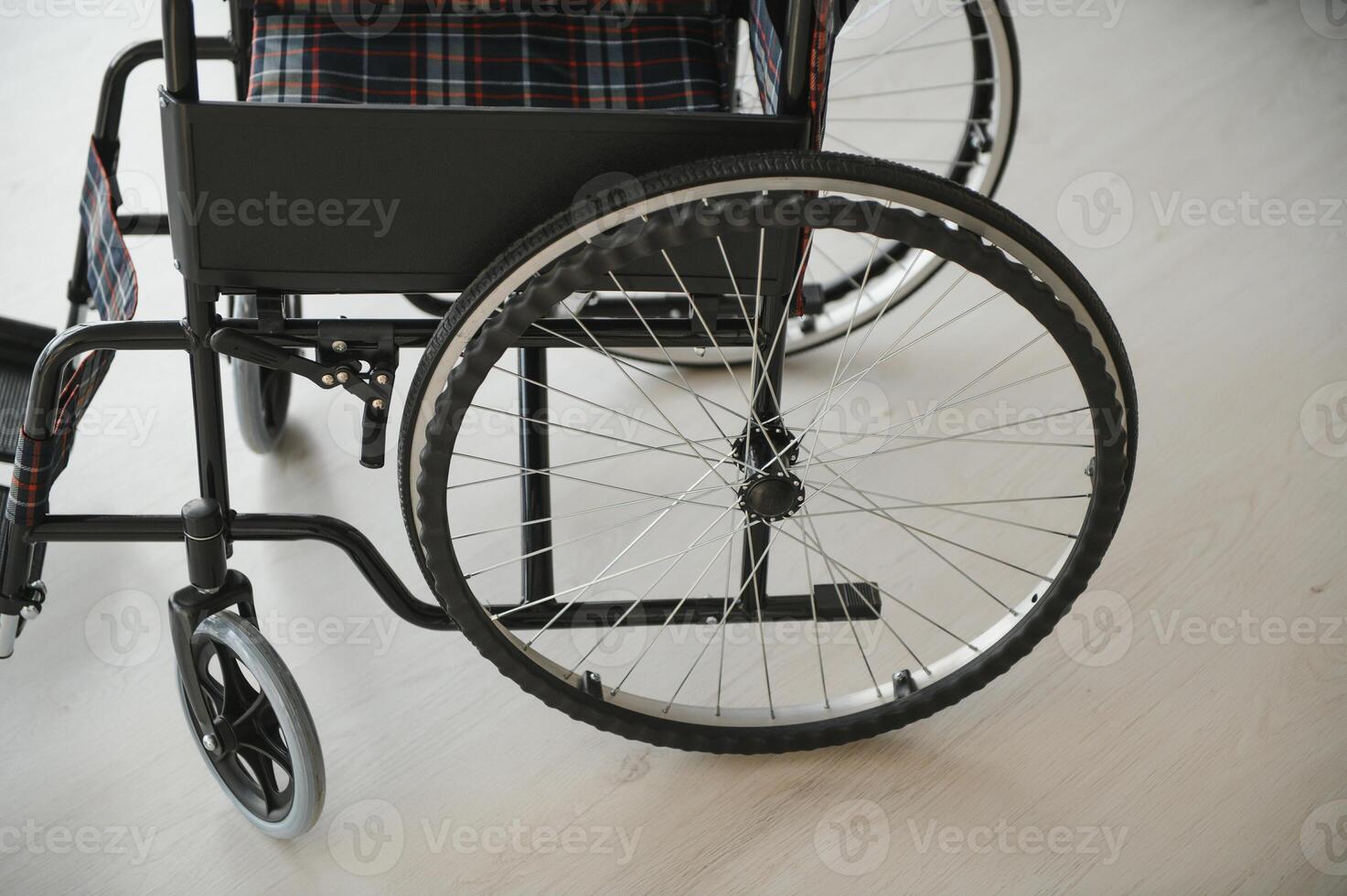 Empty wheelchair in living room next to the couch photo