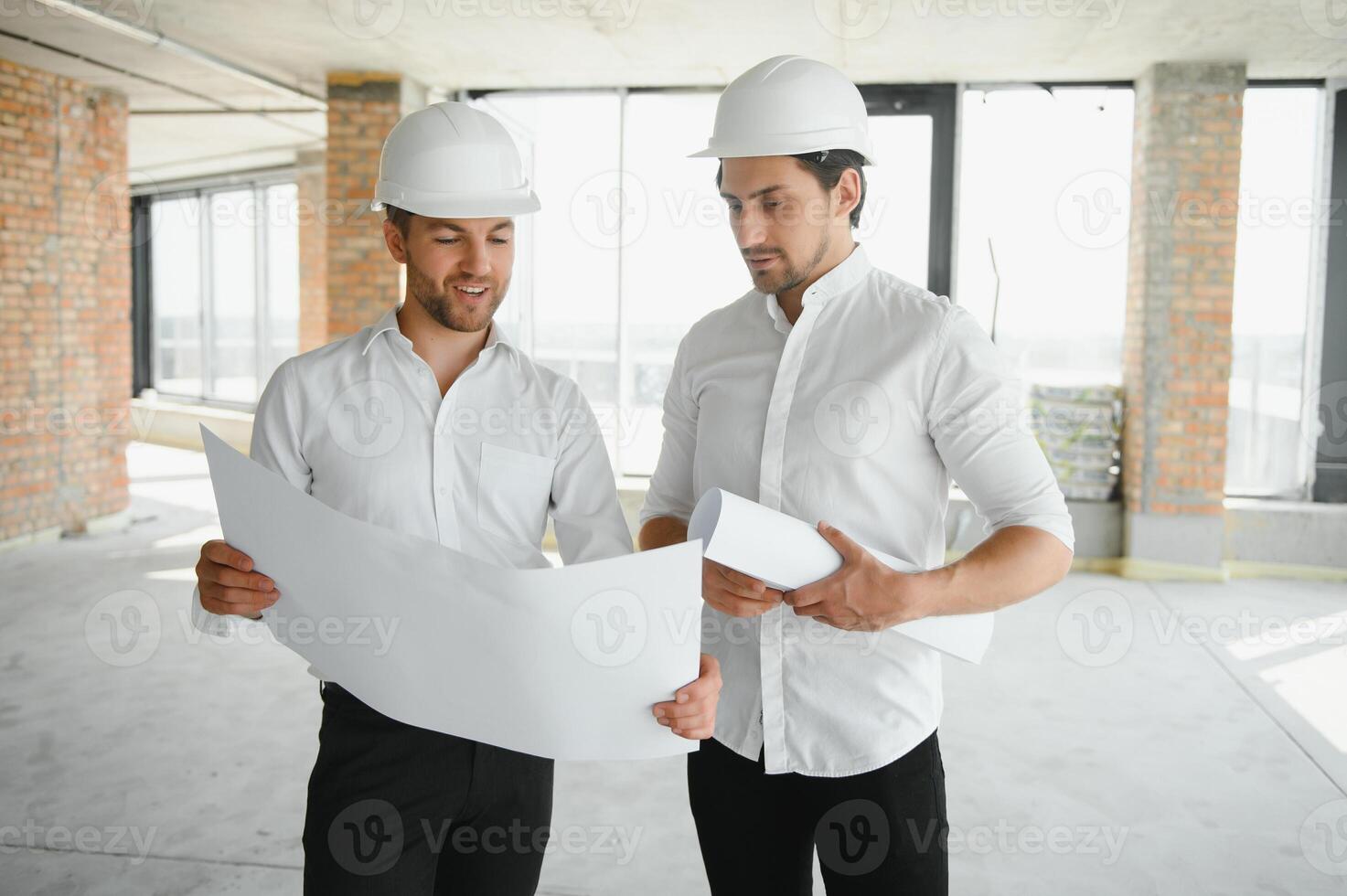 Two Specialists Inspect Commercial, Industrial Building Construction Site. Real Estate Project with Civil Engineer photo