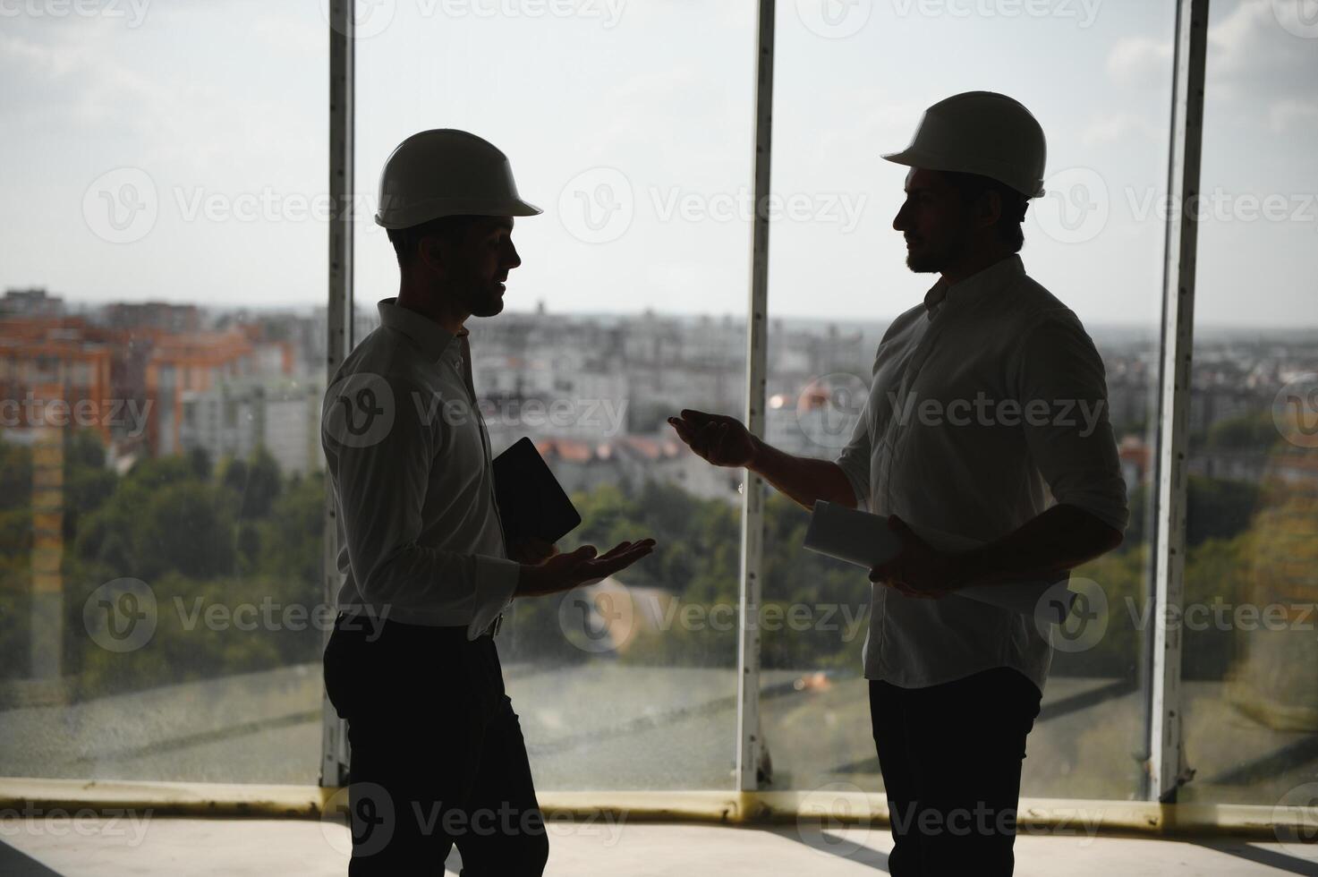 Male Architect Giving Instructions To His Foreman At Construction Site. photo