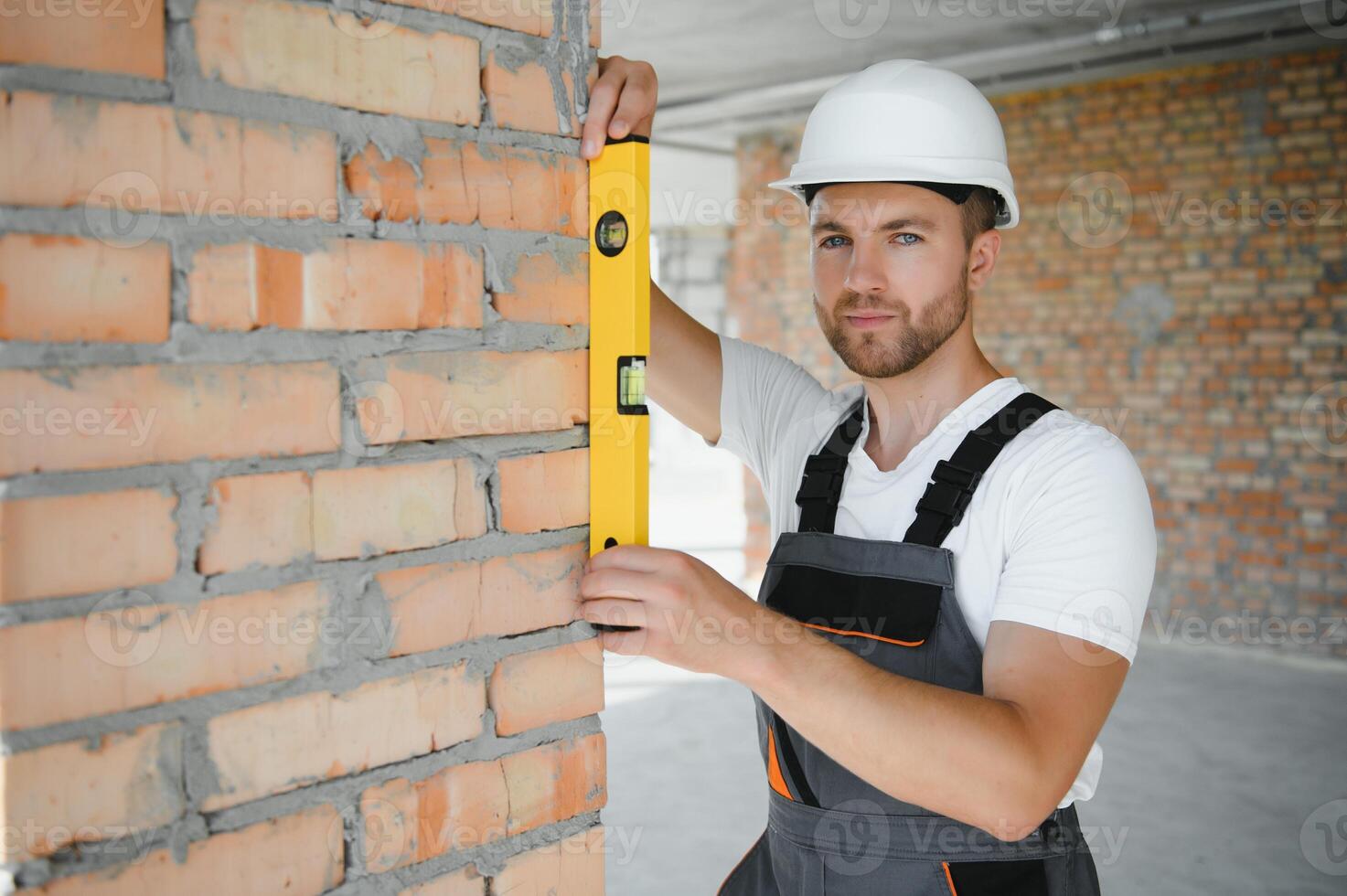 profession, construction and building - male worker or builder in helmet. photo