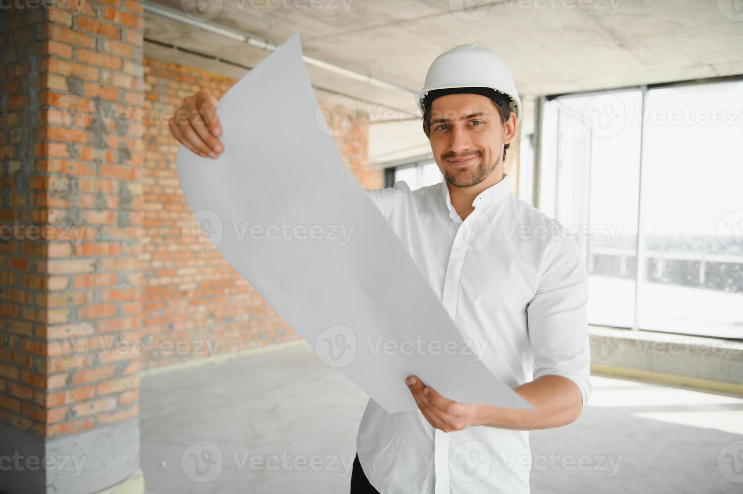 Portrait of an architect builder studying layout plan of the rooms, serious civil engineer working with documents on construction site, building and home renovation, professional foreman at work. photo