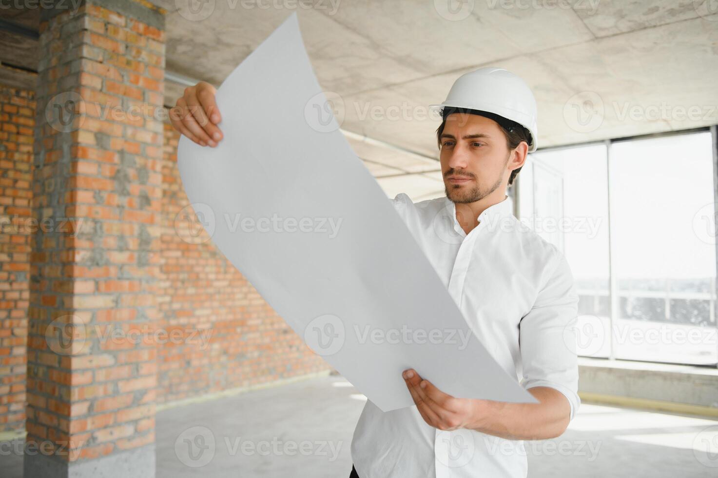 Close up engineers working on a building site holding a blueprints.Engineering and architecture concept photo